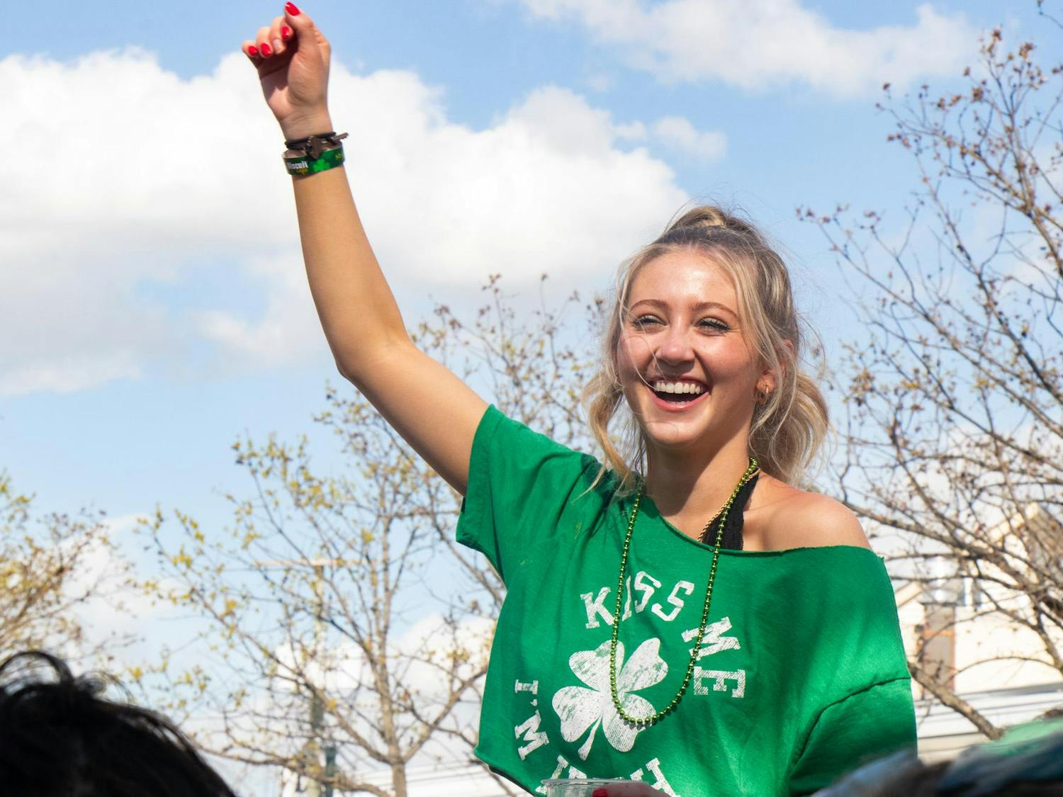 Fourth-year student Bri Conner cheers while sitting on top of another spectator's shoulders during Conner Smith’s performance at the Saluda Stage during St. Pat's in Five Points in Columbia, South Carolina on March 16, 2024. Smith, a country singer from Nashville, Tennessee, was one of many performers to take the stage during Saturday’s festival.