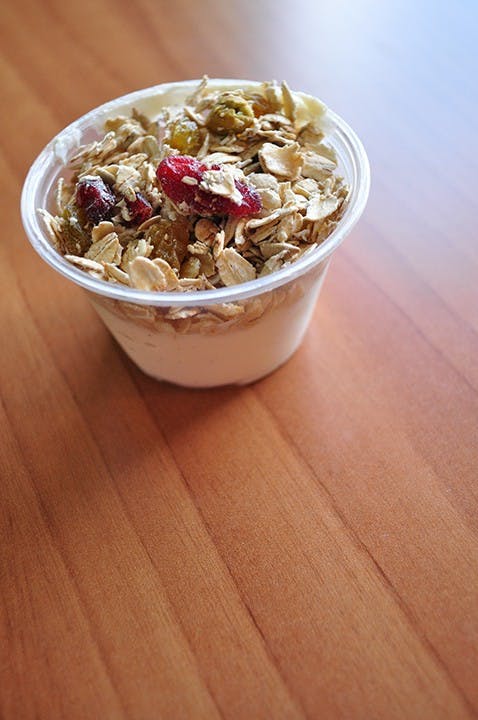 Homemade vanilla bean yogurt with granola, cranberries, golden raisins and sunflower seeds