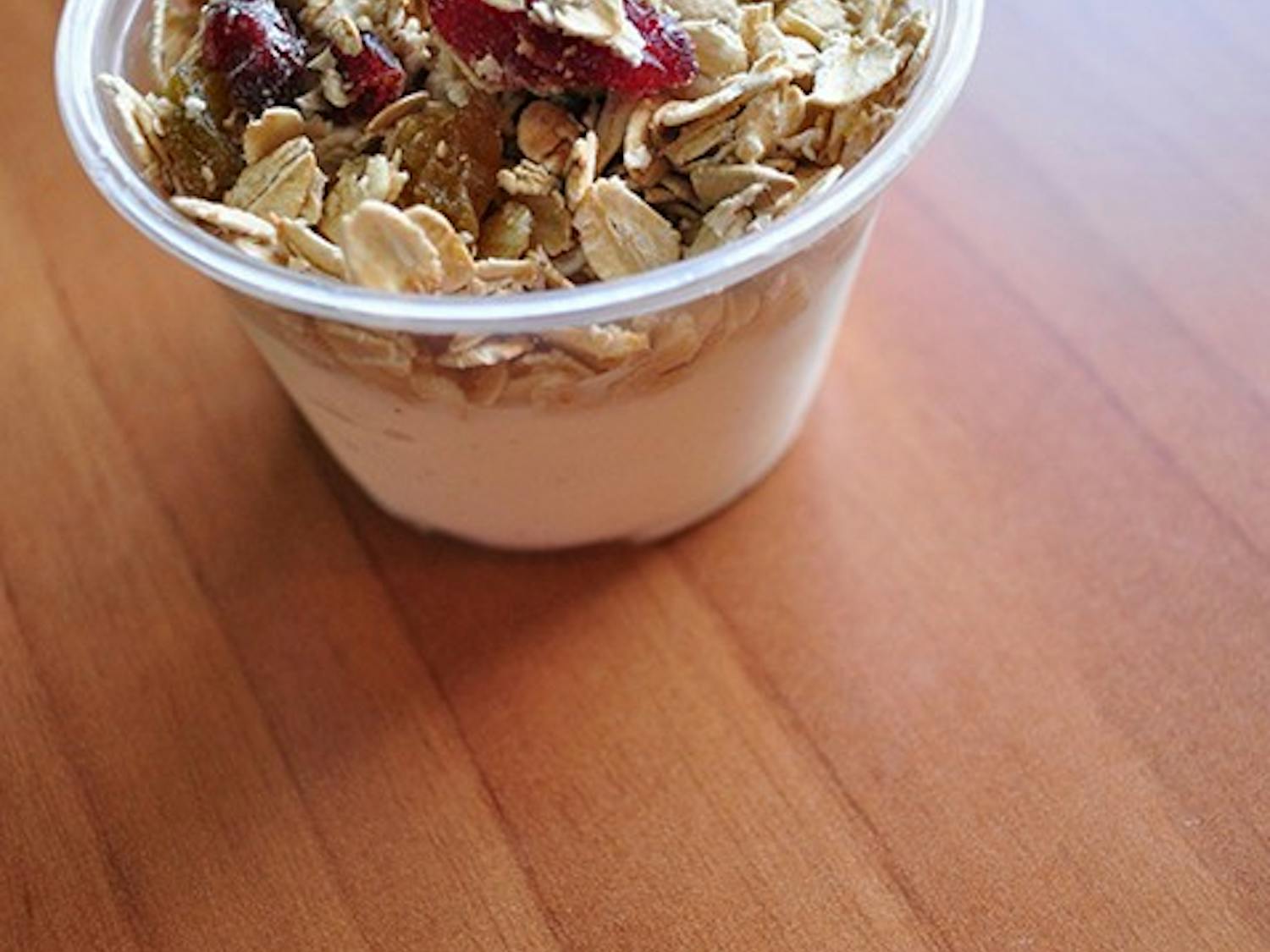 Homemade vanilla bean yogurt with granola, cranberries, golden raisins and sunflower seeds