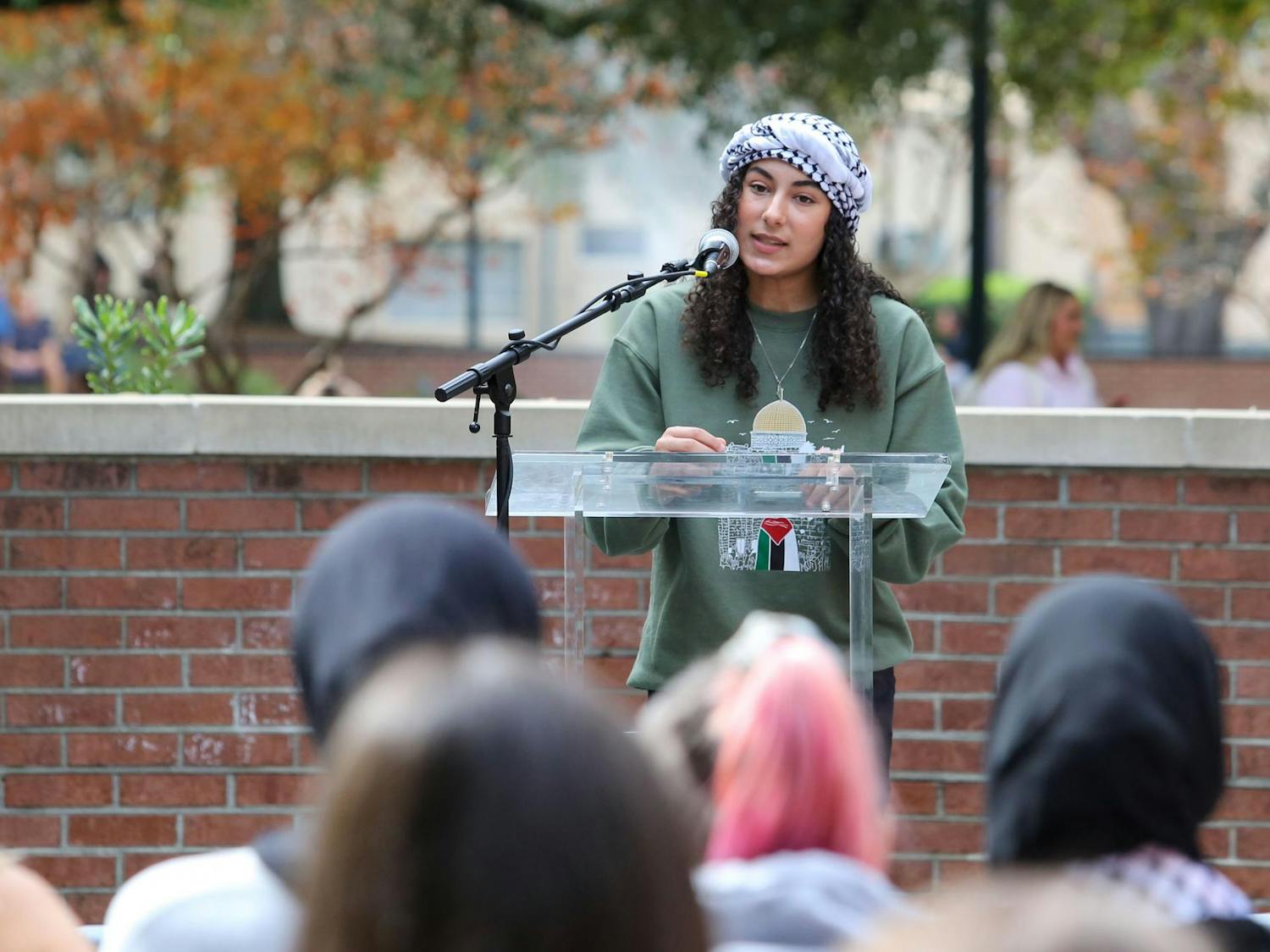 Sadeen Sarhan, a second-year cardiovascular technology student, speaks on stage during a walkout for Palestine on the Russell House Patio on Nov. 9, 2023. The event was held by the USC Arab Student Association, Jewish Voice for Peace, Dawah on Campus, Students for Socialism and Students for Justice in Palestine.