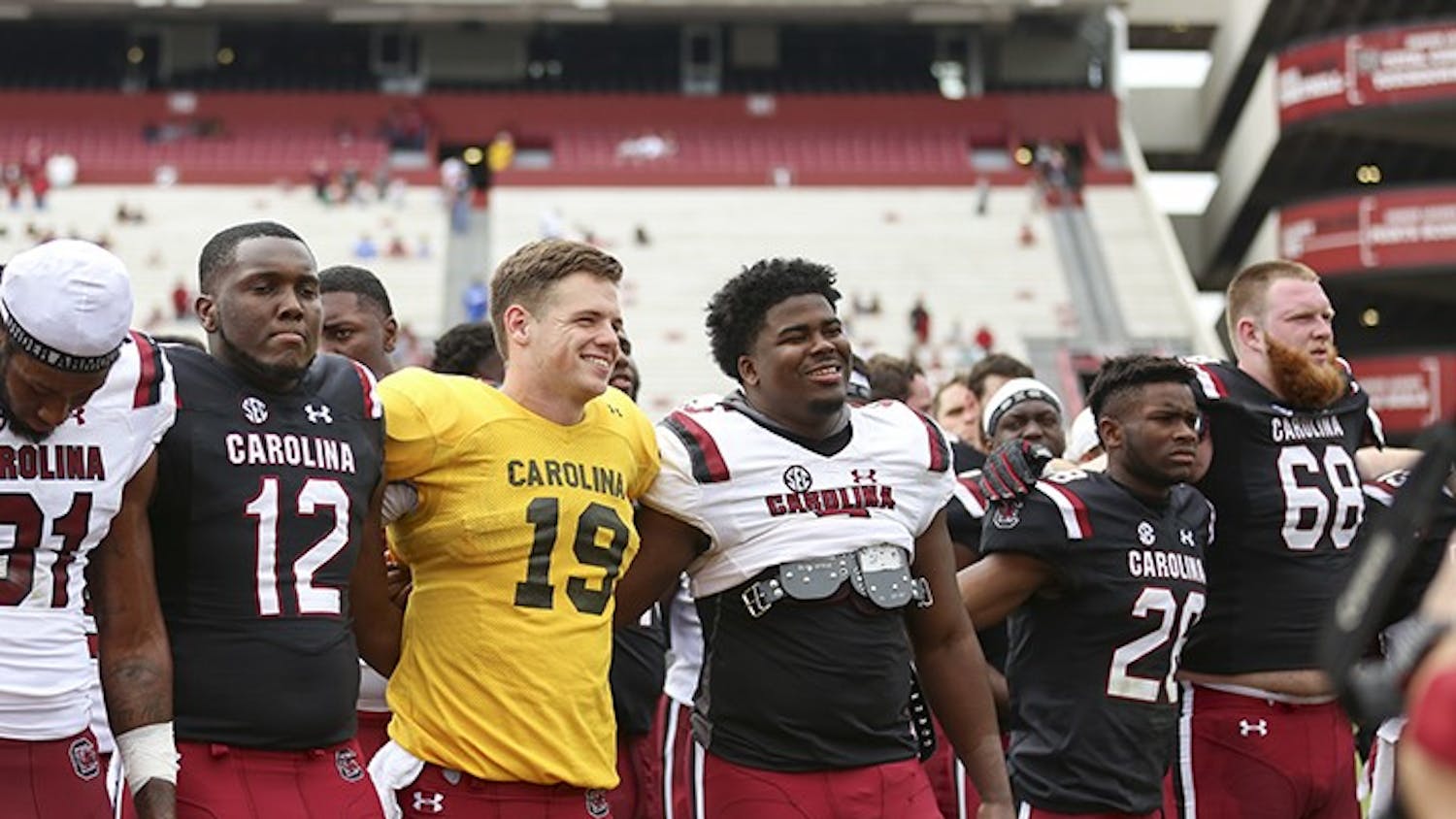 Seniors Jake Bentley and Javon Kinlaw smile during the alma mater following the spring game at Williams-Brice Stadium on Saturday.&nbsp;
