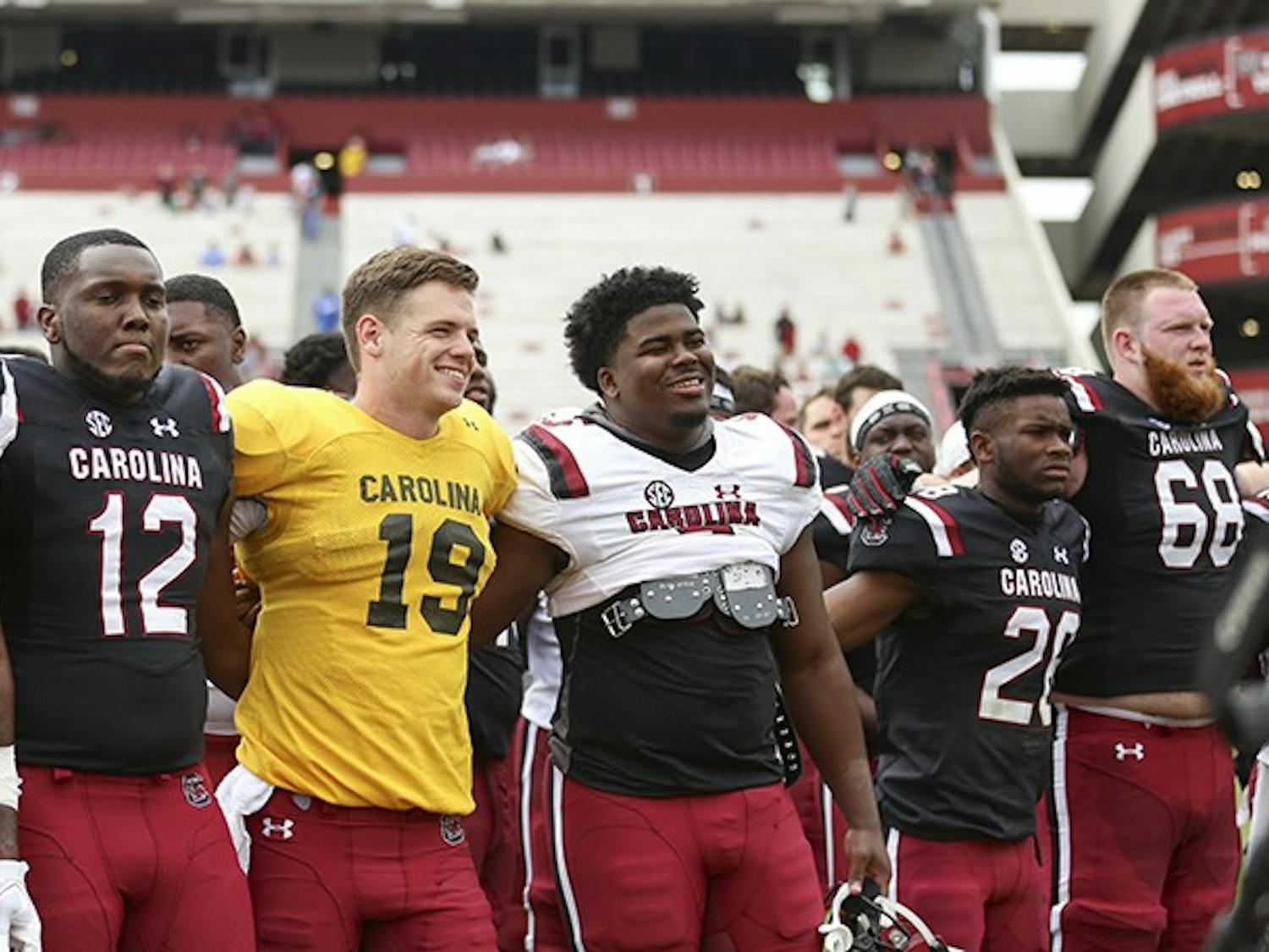 Seniors Jake Bentley and Javon Kinlaw smile during the alma mater following the spring game at Williams-Brice Stadium on Saturday.&nbsp;