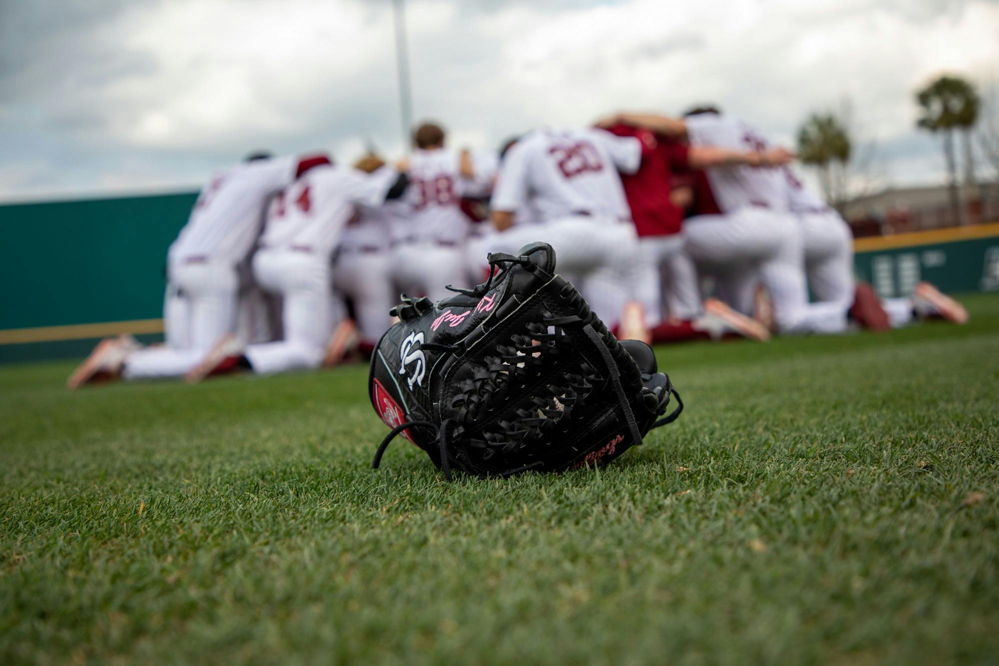 FILE—Closeup of a glove as the South Carolina baseball team huddles before a game against Appalachian State on Tuesday, March 1, 2022.