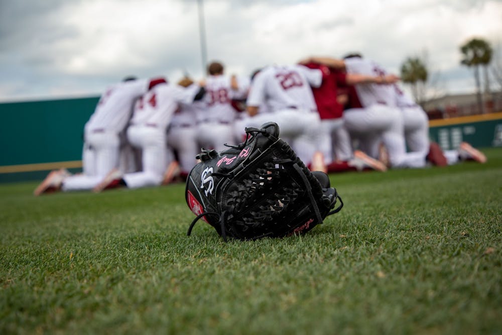 <p>FILE—Closeup of a glove as the South Carolina baseball team huddles before a game against Appalachian State on Tuesday, March 1, 2022.</p>