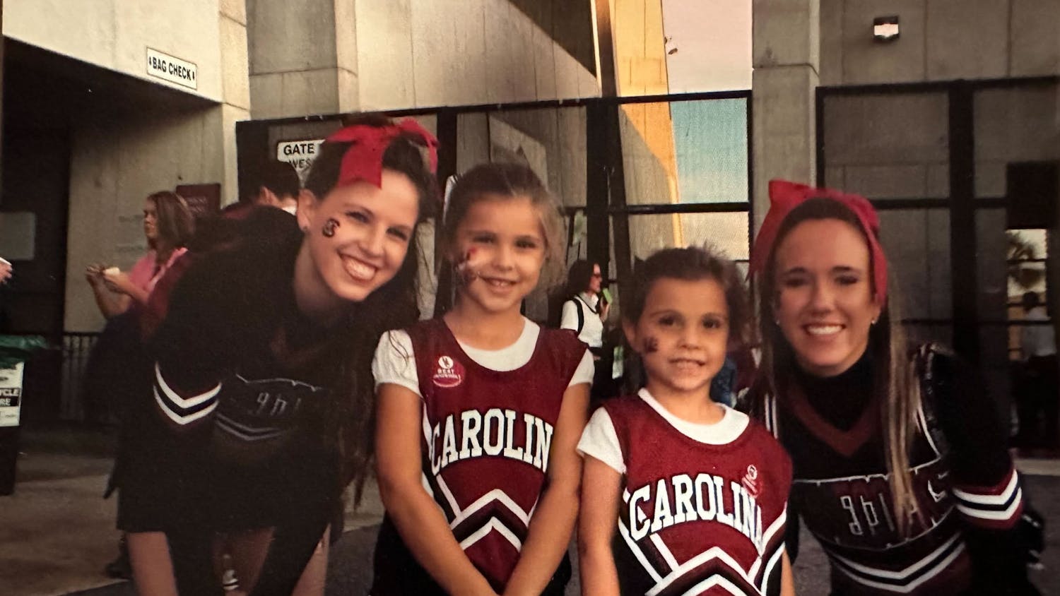 Camila and Sophia Burnett pose next to Gamecock cheerleaders in their own cheerleading outfits. Growing up as Gamecock fans in Hilton Head, S.C., the sisters said attending games was not an uncommon occurrence for their family.