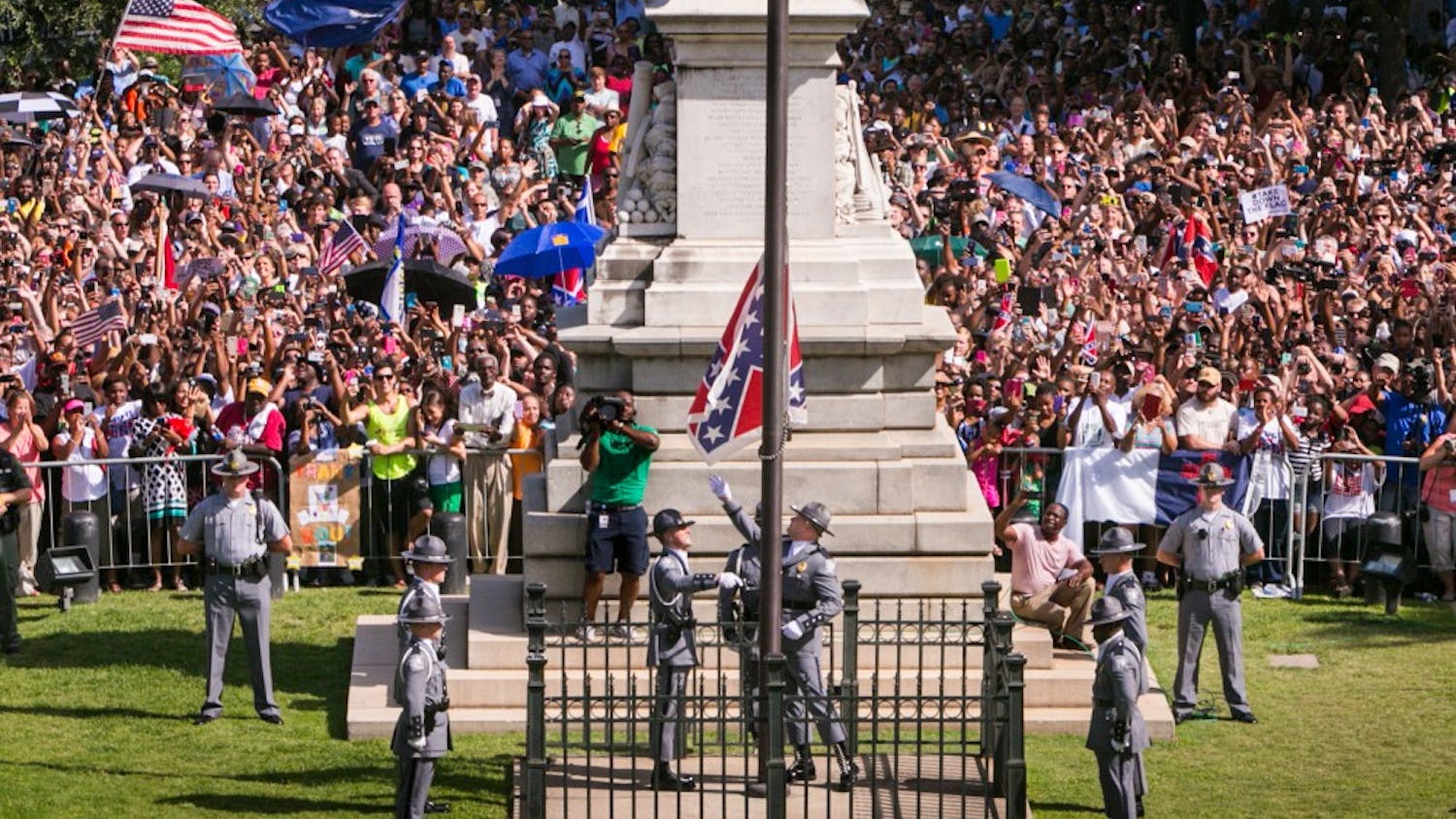 The South Carolina Highway Patrol Honor Guard removes the Confederate Battle Flag from the State House grounds during a ceremony on Friday, July 10, 2015, in Columbia, S.C. (Tim Dominick/The State/TNS)