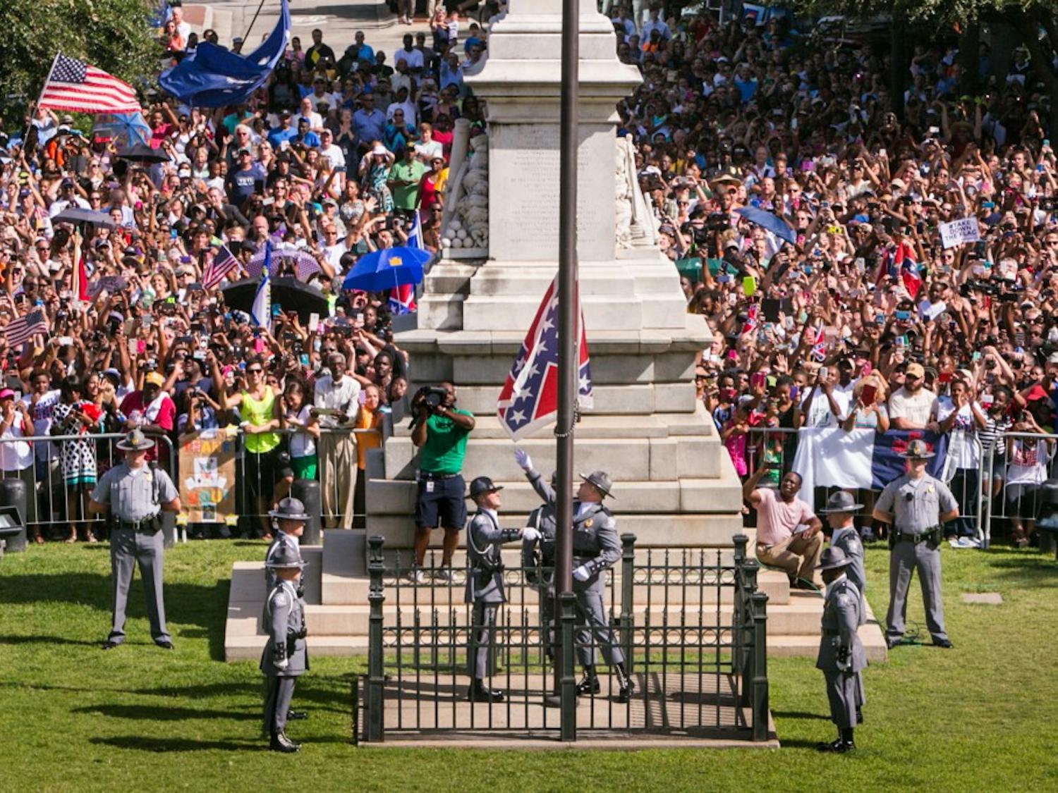 The South Carolina Highway Patrol Honor Guard removes the Confederate Battle Flag from the State House grounds during a ceremony on Friday, July 10, 2015, in Columbia, S.C. (Tim Dominick/The State/TNS)