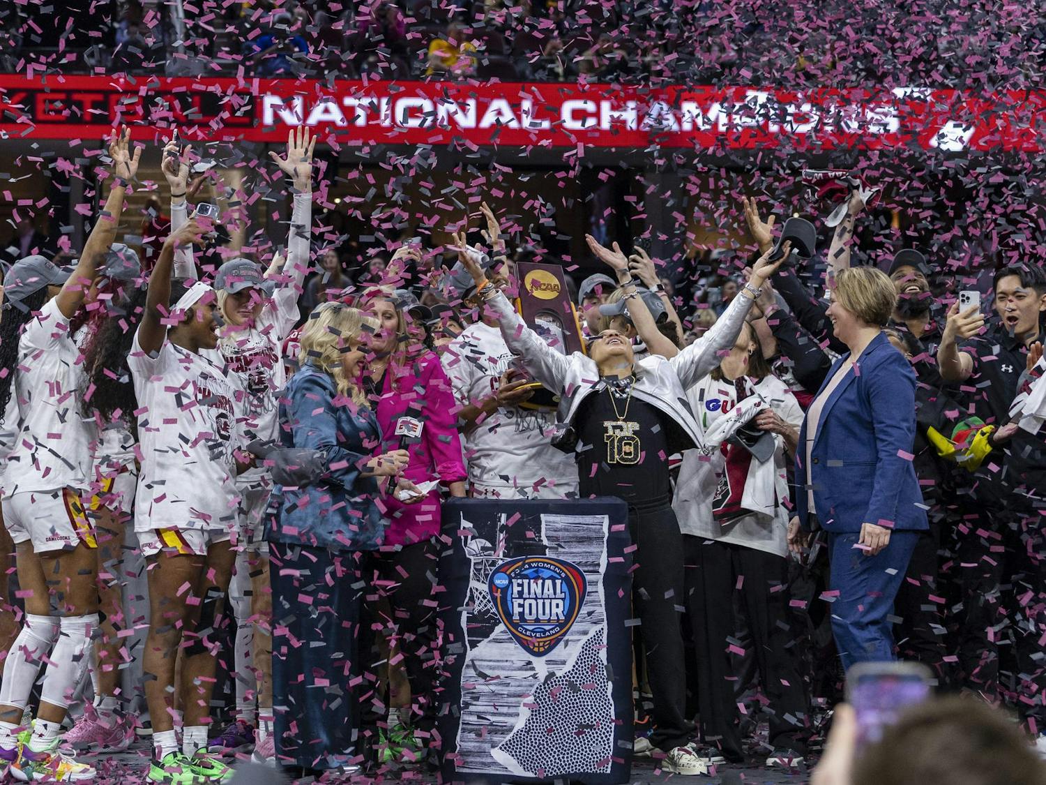 Confetti falls as the Gamecock women's basketball team celebrates earning a national title on stage in Rocket Mortgage FieldHouse. This victory completed the "revenge tour" and an undefeated season for the Gamecocks.