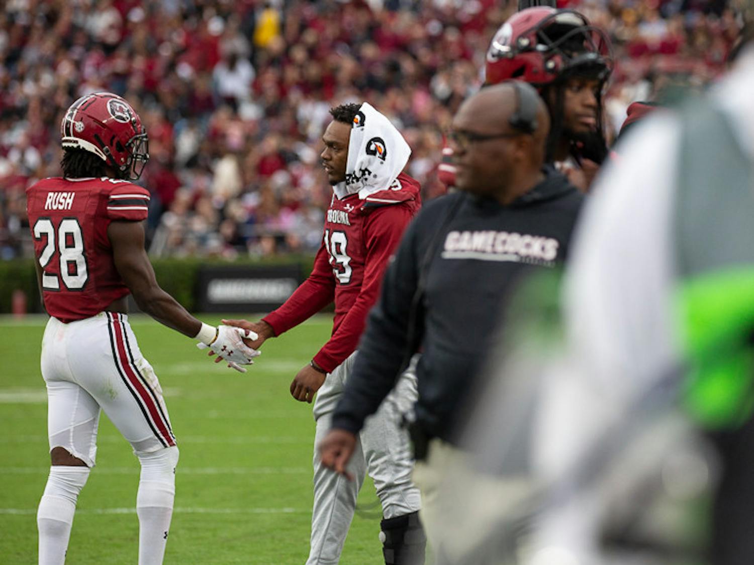 Sixth-year linebacker Brad Johnson (on right) greets redshirt senior defensive back Darius Rush after the team takes a timeout. South Carolina lost to Missouri 23-10.