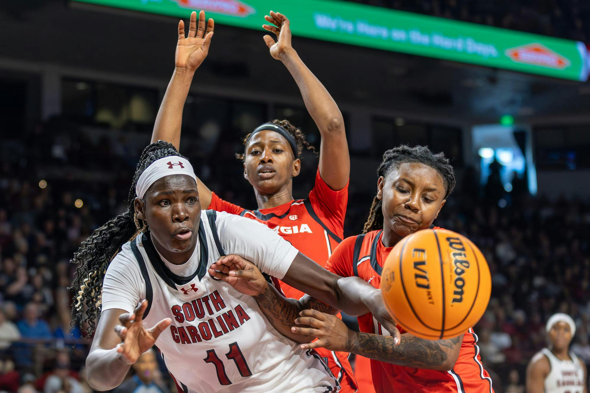 Senior center Madina Okot attempts to grab the ball while flanked from behind by two opposing players during the game against Georgia on Jan. 11, 2026. Okot tied with sophomore forward Joyce Edwards for most points with 14 each.