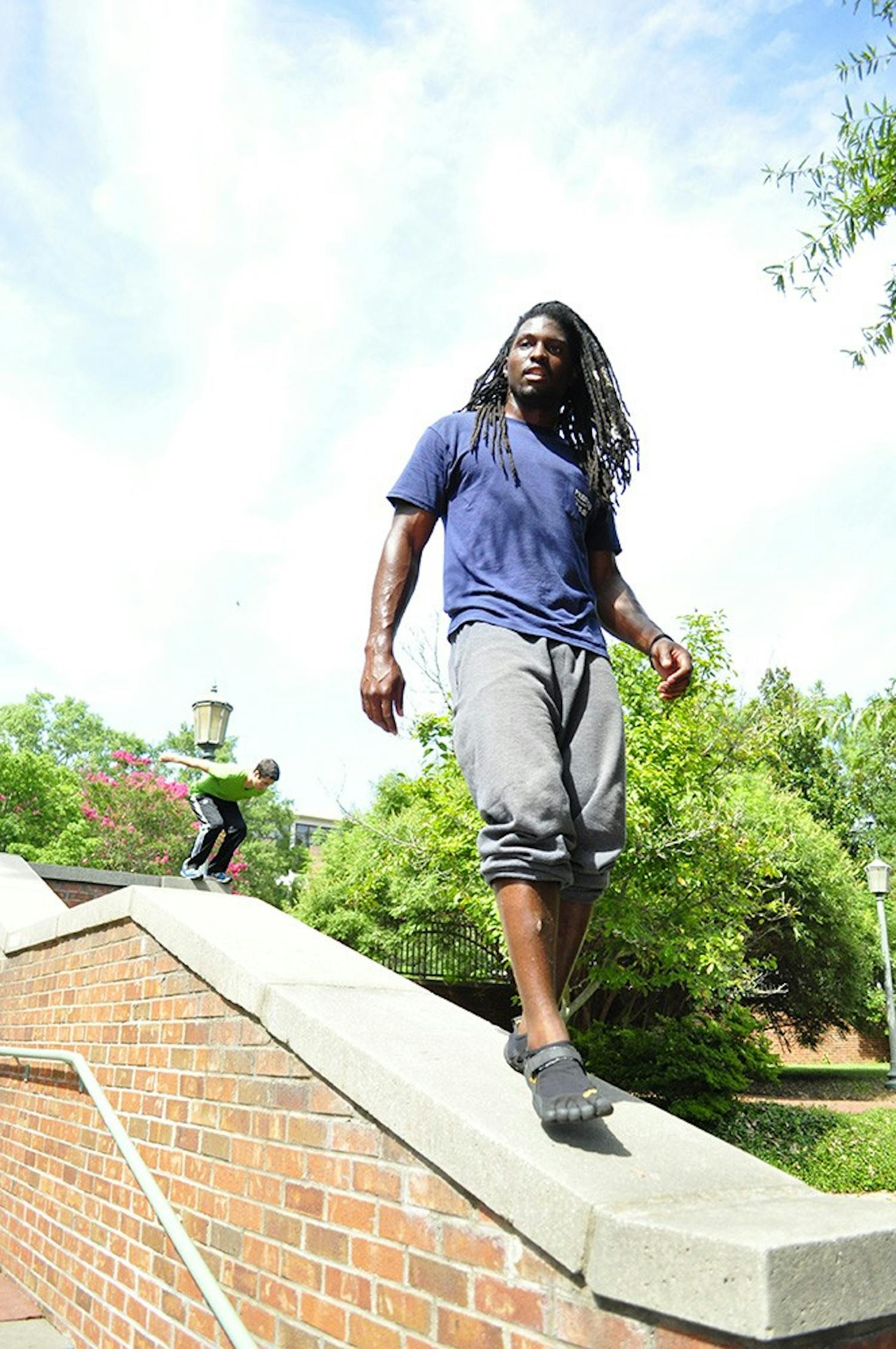 	Marquis Johnson, a second-year marketing student walking along a wall top near Russell House.