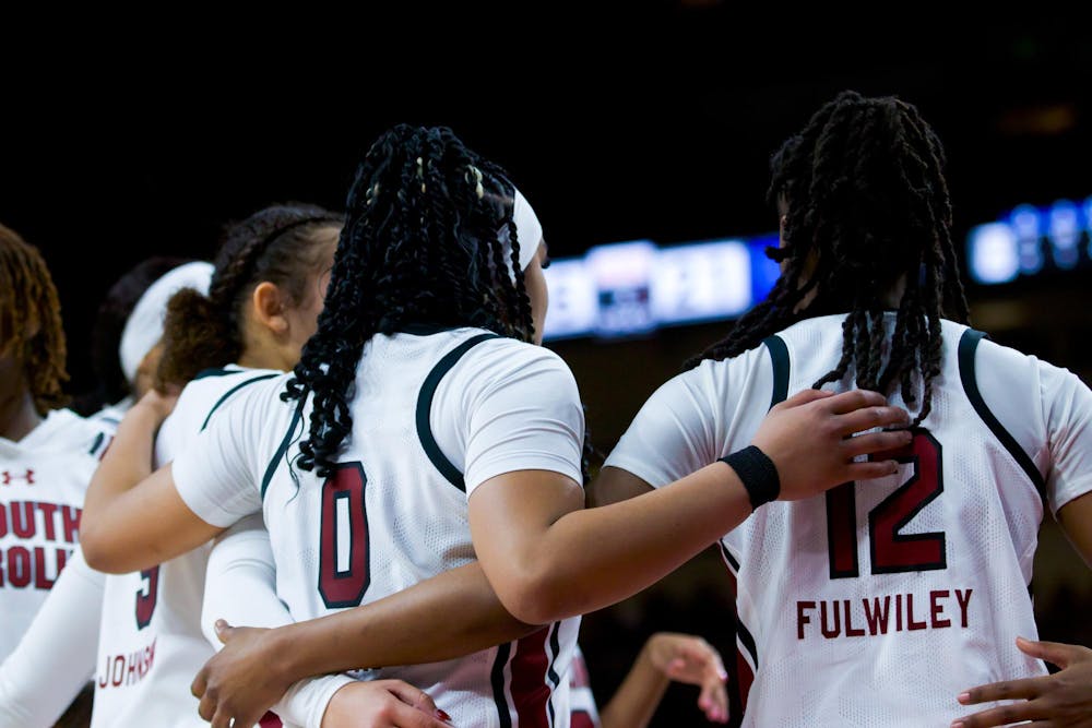 <p>Freshman guard Tessa Johnson, senior guard Te-Hina Paopao and freshman guard MiLaysia Fulwiley huddle together during a timeout against the Wildcats. Combined, the three players attributed 39 points to South Carolina’s score of 98-36 against Kentucky on Jan. 15, 2023.&nbsp;</p>