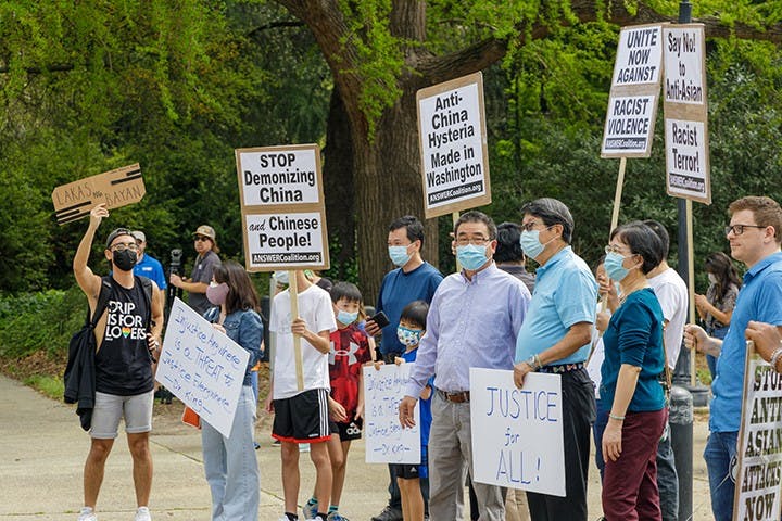  A group holds signs in protest of Asian hate that is happening within Asian communities.
