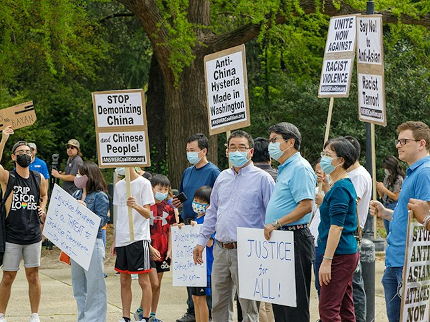  A group holds signs in protest of Asian hate that is happening within Asian communities.
