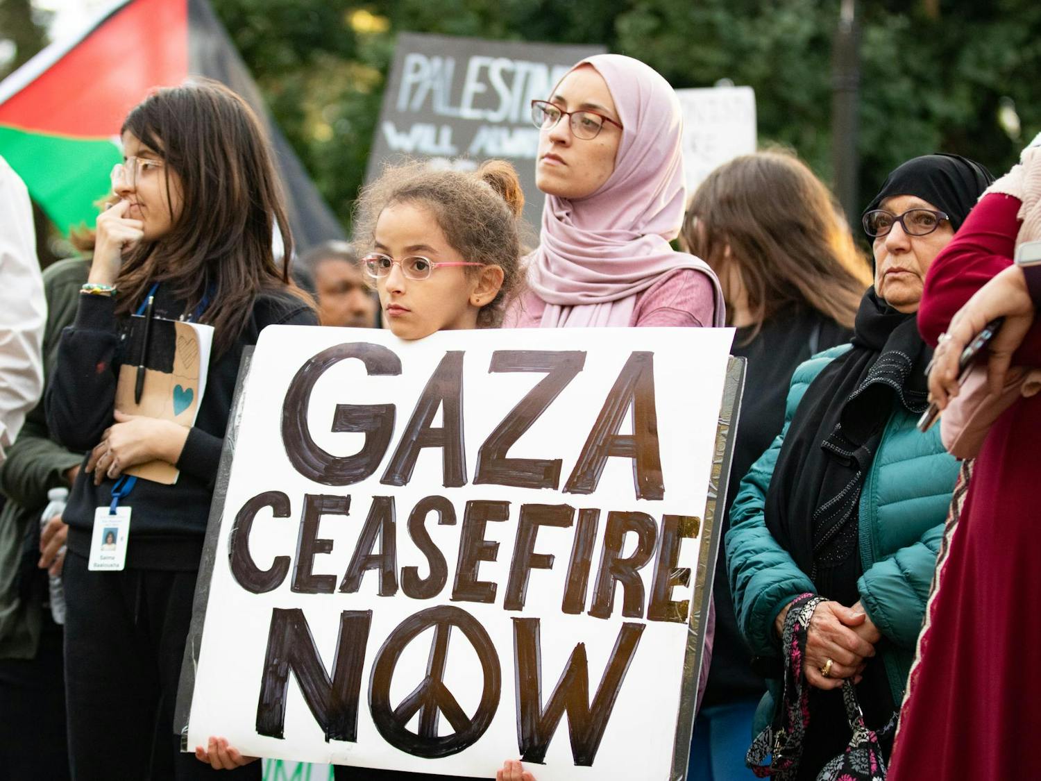 A child at the Free Palestine rally holds a sign reading "Gaza ceasefire now" as she watches speakers at the protest. Members of the North and South Carolina Party for Social Liberation organized the rally held on Statehouse grounds in Columbia, S.C., on Oct. 17, 2023.