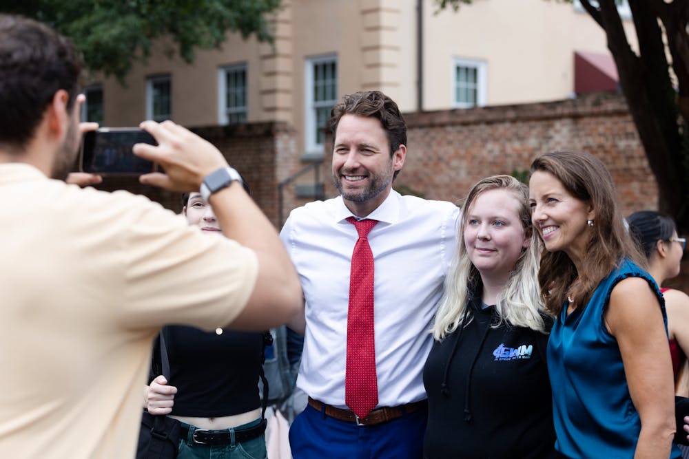 Joe Cunningham and his running mate Tally Casey pose for a picture with students on Greene Street on Aug. 25, 2022. The candidates for governor and lieutenant governor met with students during the organization fair. 