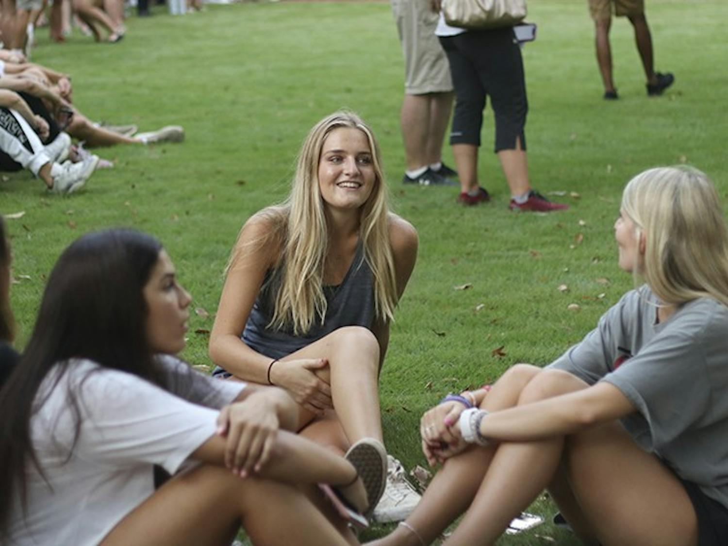 Students laugh and talk as they wait for "First Night Carolina" festivities to begin on the horseshoe, Wednesday evening.&nbsp;