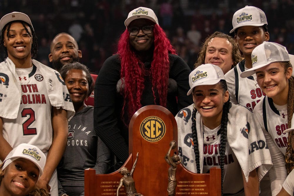 <p>South Carolina women’s basketball players accept and surround the 2023-2024 SEC Conference Championship trophy at Colonial Life Arena on Feb. 22, 2024. South Carolina defeated Alabama 72-44 — a victory that marked head coach Dawn Staley’s 600th career win as head coach.</p>