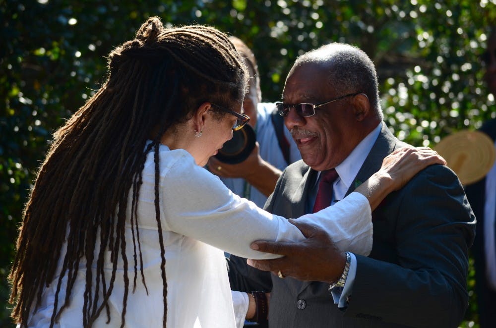 	USC visiting professor Nikky Finney greets James Solomon Jr., one of the first black students to enroll at the university.