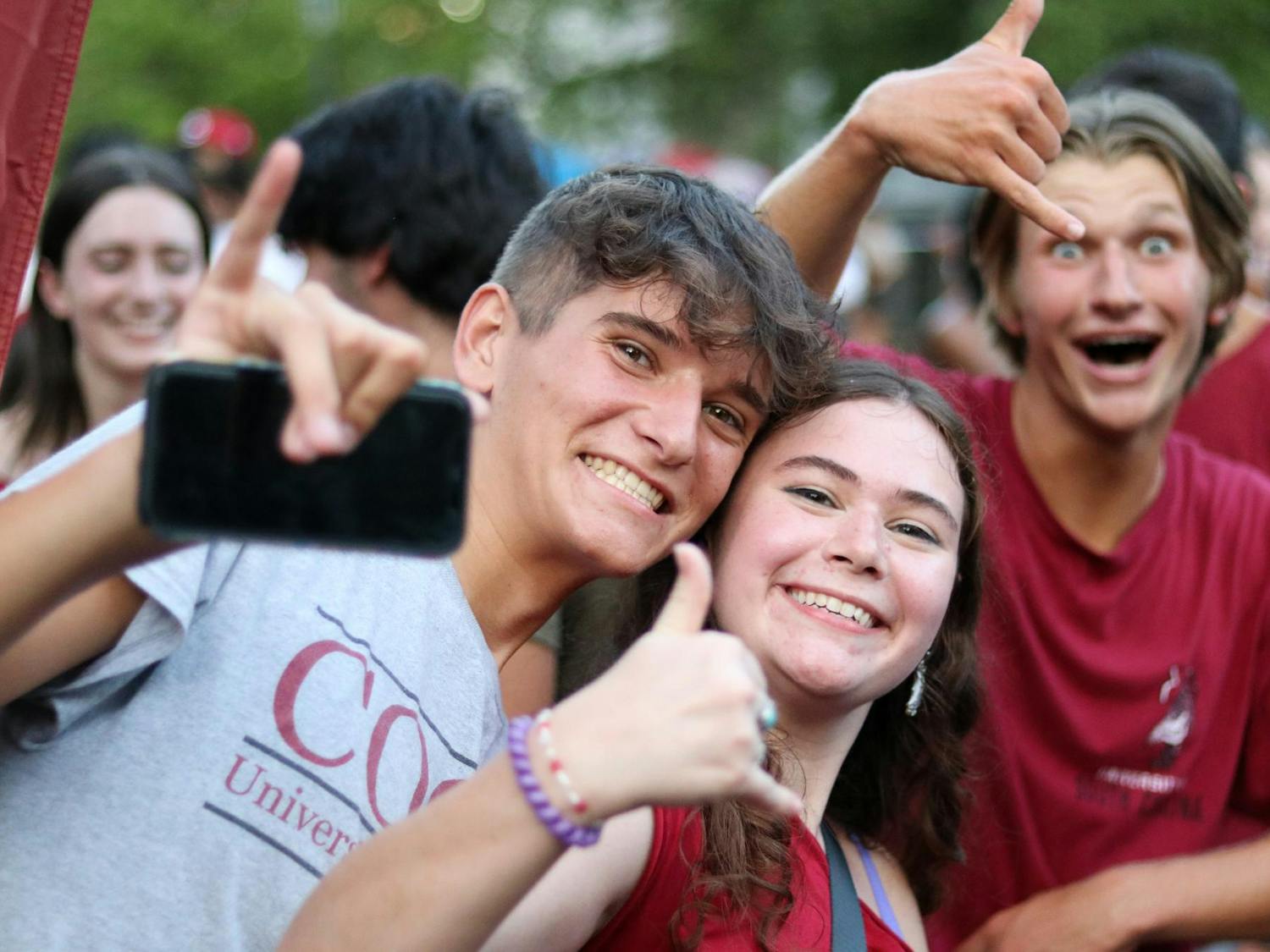 First Night Carolina attendees make a "spurs up" motion with their hands on Greene Street. Gamecock Entertainment hosts First Night Carolina every year as part of the “Carolina Welcome” series of events.