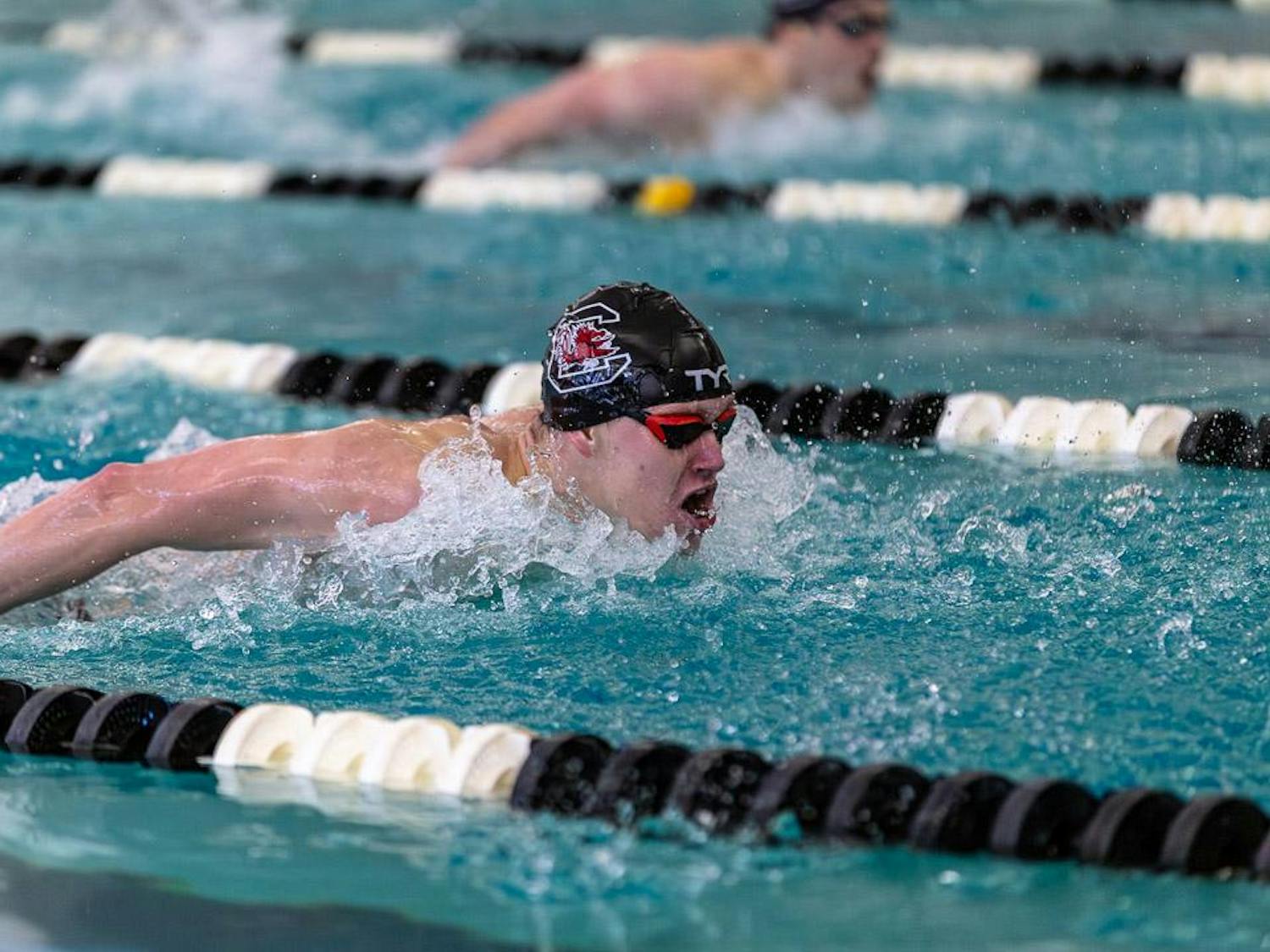 Sophomore swimmer Gage Hulbert takes a breath during the first heat of the 200-meter butterfly event against Duke University at the Carolina Natatorium on Jan. 20, 2024. Hulbert finished in first place in the event.