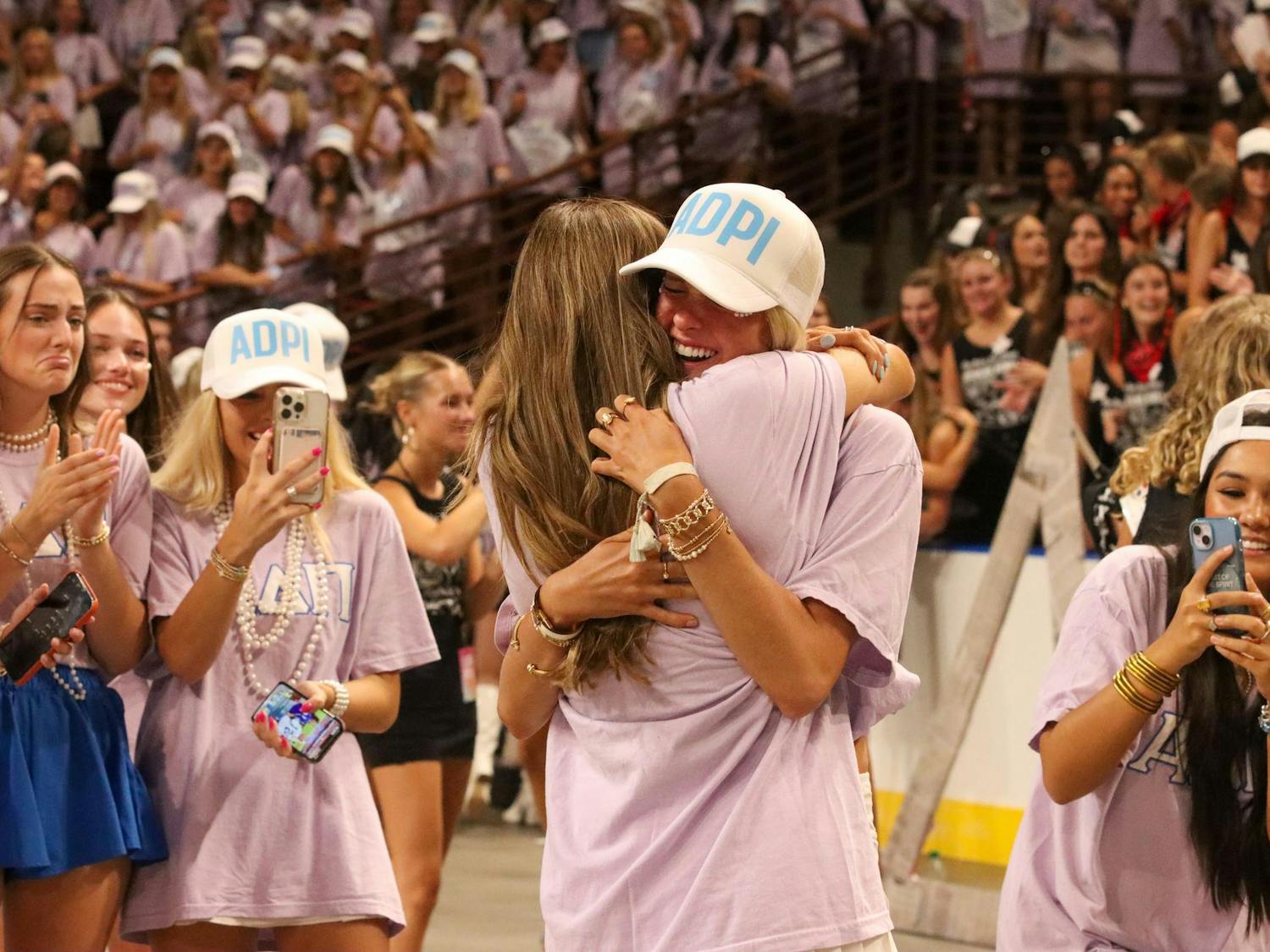 A member of Alpha Delta Pi greets a PNM with an embrace on bid day Aug. 25, 2024 at Colonial Life Arena. The arena was full of excitement as many sprinted to find their new home.