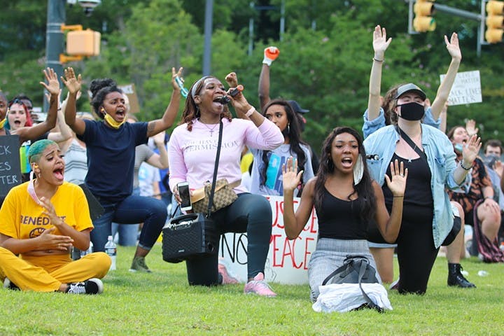 Protestors kneeled in front of the Statehouse facing the police dressed in riot gear. The police in riot gear arrived at approximately 4:30 p.m.