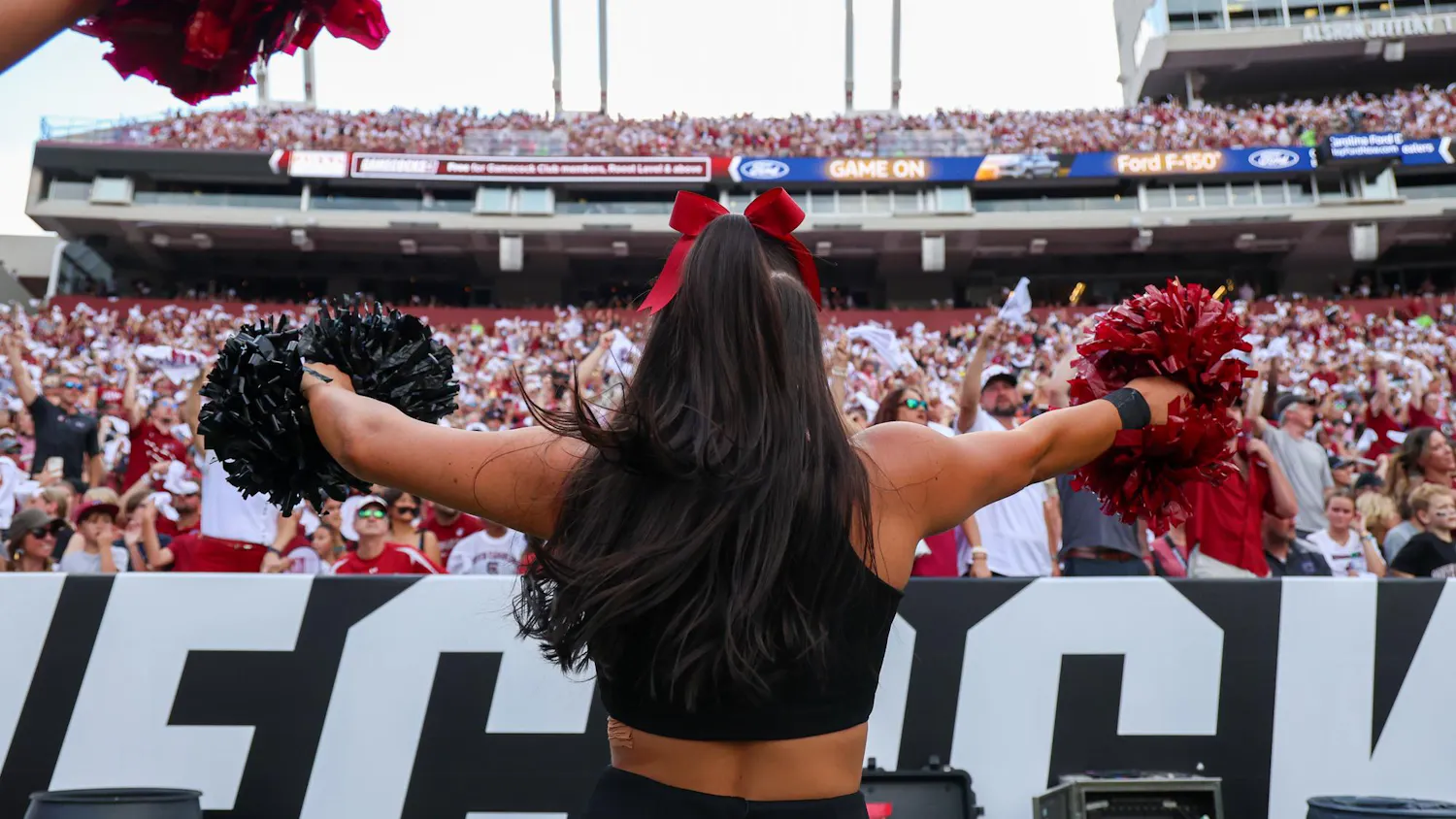 FILE — A South Carolina cheerleader dances in front of the home team side at Williams-Brice Stadium during a football game on Aug. 31, 2024.