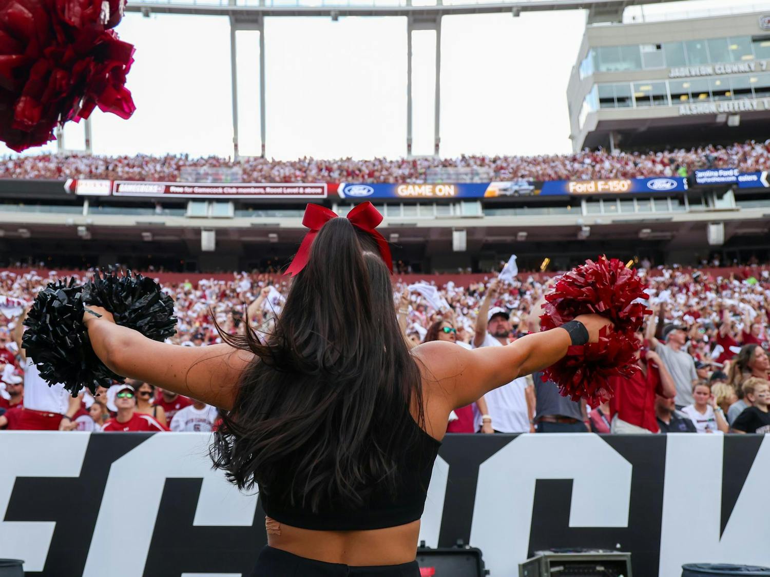 FILE — A South Carolina cheerleader dances in front of the home team side at Williams-Brice Stadium during a football game on Aug. 31, 2024.