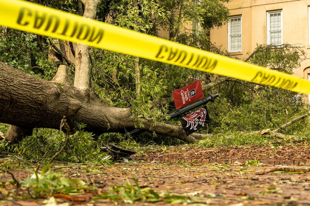 <p>A fallen tree outside DeSaussure Hall with caution tape around it on the University of South Carolina Horseshoe on Sept. 27, 2024. Trees and other debris were scattered across campus after Hurricane Helene made landfall.</p>