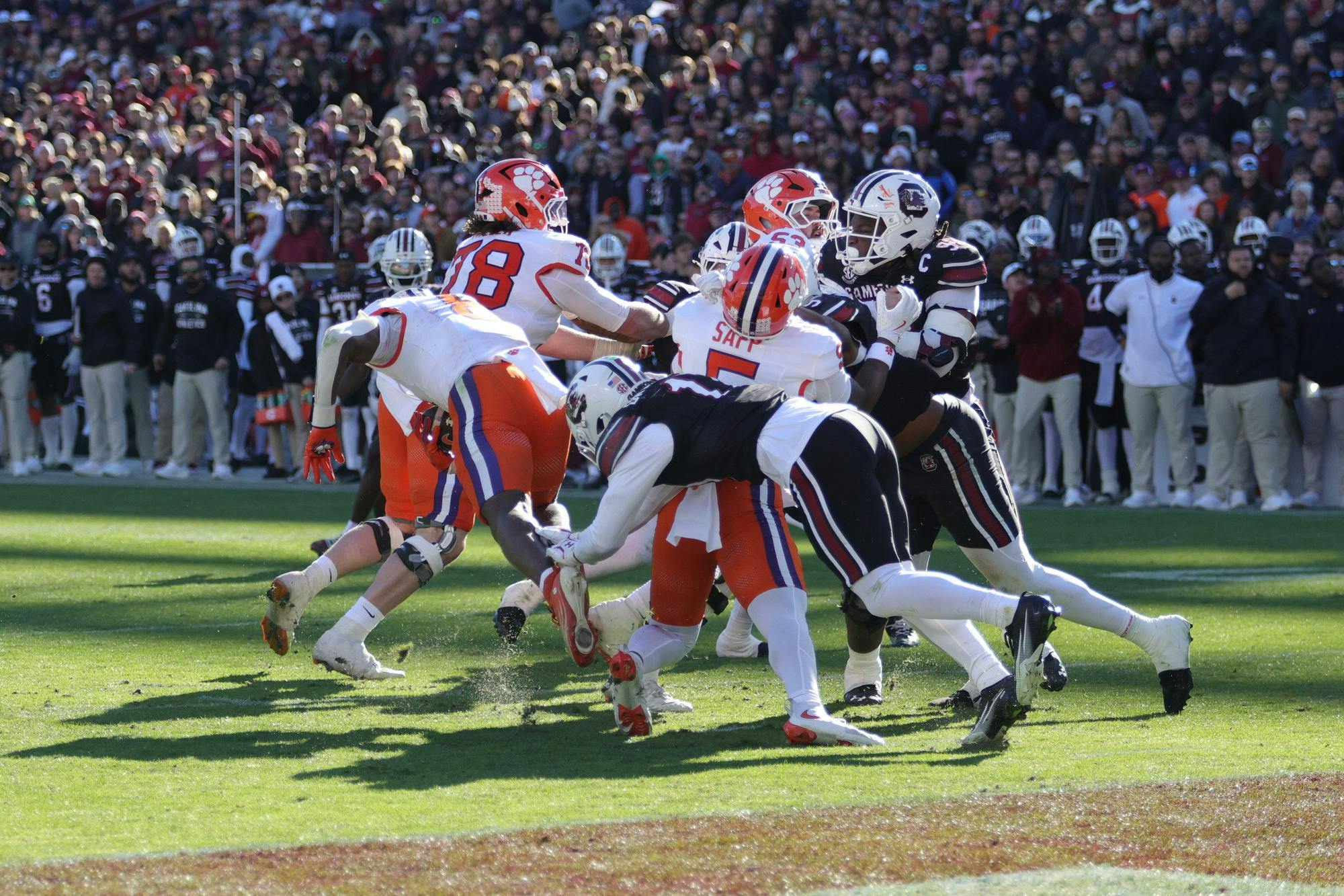 South Carolina players push forward during a short-yardage play against Clemson on Nov. 29, 2025, at Williams-Brice Stadium. The Gamecocks fight for extra yards as the offense battles at the goal line during the rivalry game.
