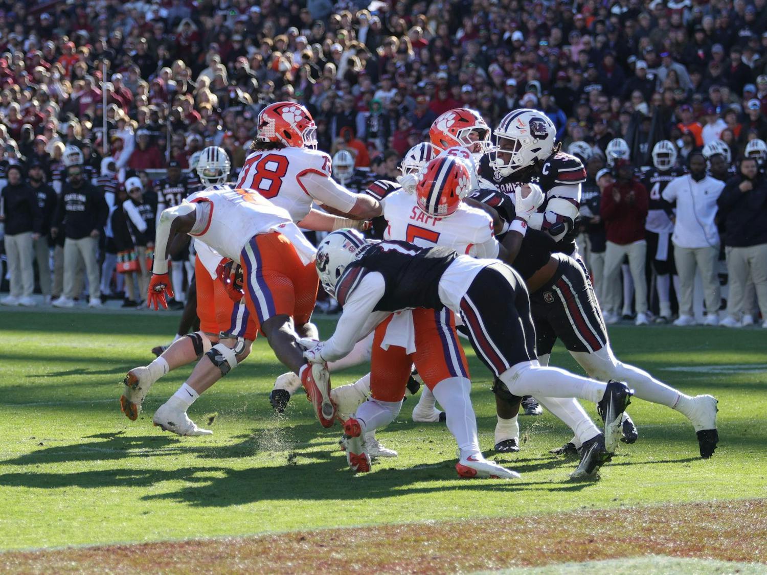 South Carolina players push forward during a short-yardage play against Clemson on Nov. 29, 2025, at Williams-Brice Stadium. The Gamecocks fight for extra yards as the offense battles at the goal line during the rivalry game.