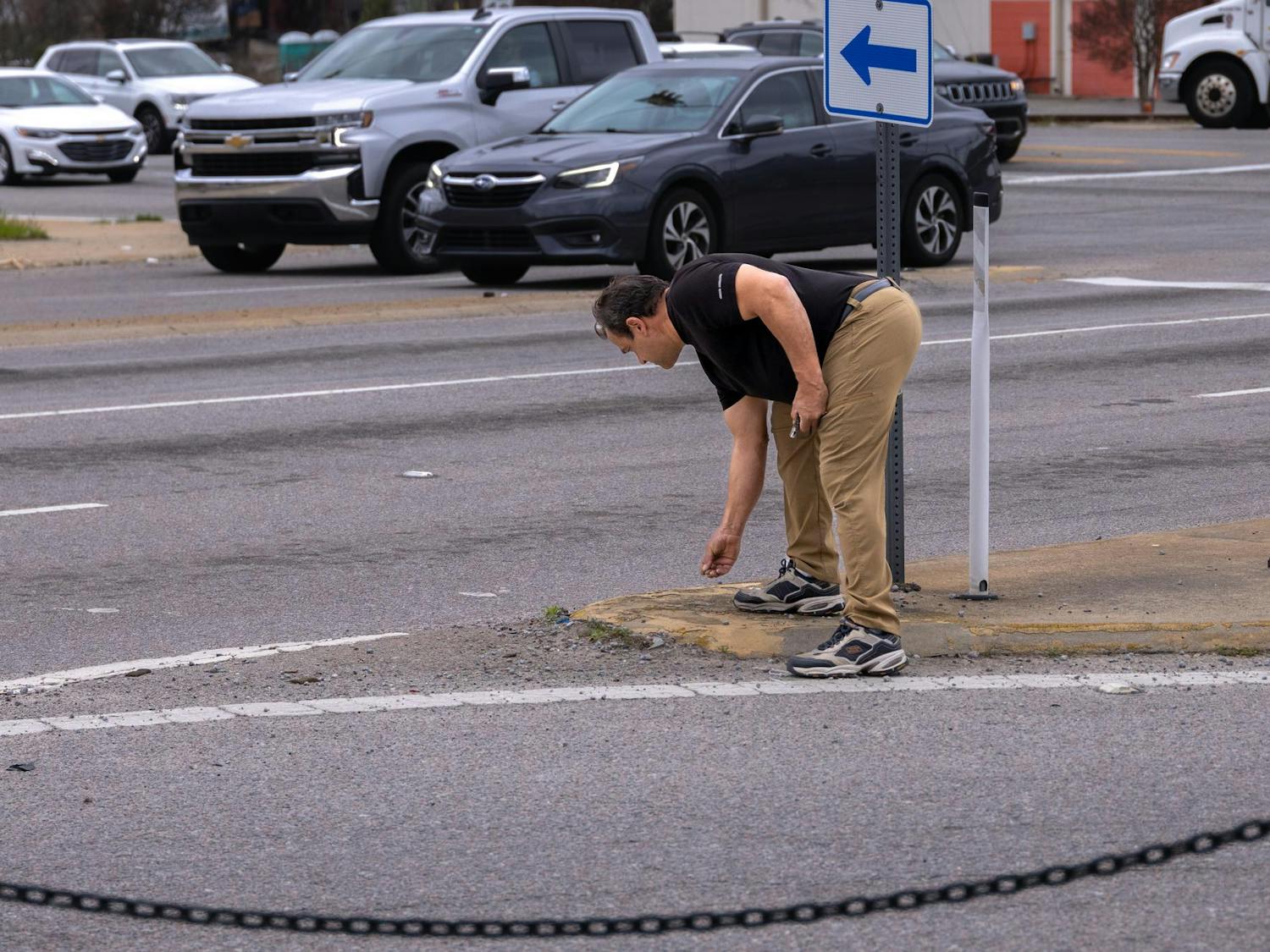 Humphries collects scrap metal materials on the corner of Rosewood Drive and George Rogers Boulevard on Feb. 27, 2024. The artist constantly looked for pieces that can be used in his art and found more than 10 items to bring back to his workshop in less than an hour.