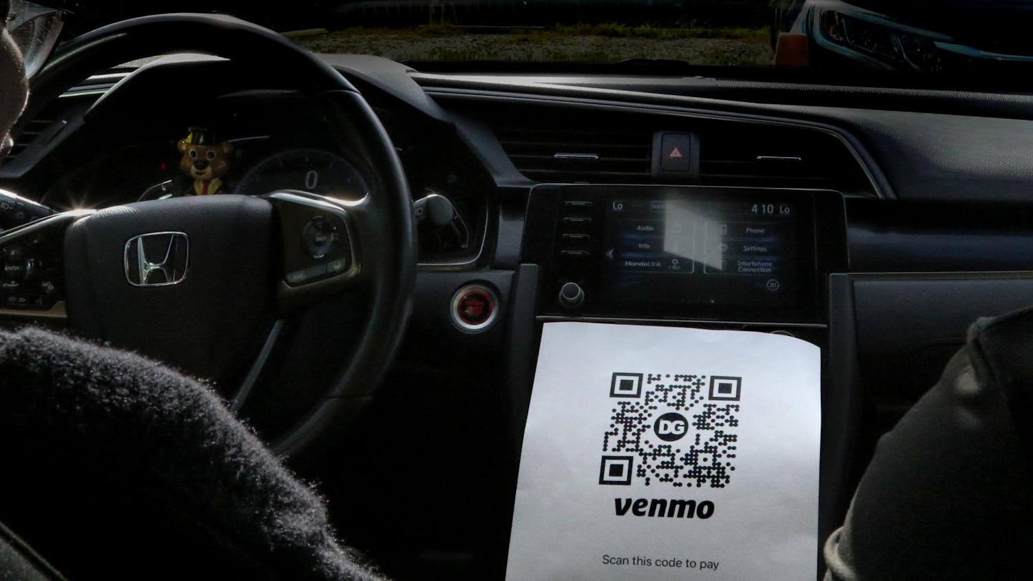 A photo illustration of two girls in their car simulating "safe rides" on Oct. 25, 2023. "Safe rides," a predominantly female GroupMe of drivers, has increased prices.