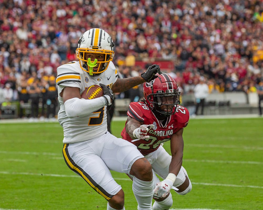 <p>Redshirt senior defensive Back Darius Rush attempts to pick the ball from Missouri's running back during the South Carolina vs. Missouri Game on Oct. 29, 2022. The Tigers beat the Gamecocks 23-10.</p>