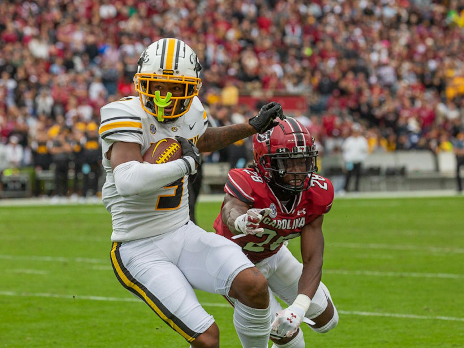 Redshirt senior defensive Back Darius Rush attempts to pick the ball from Missouri's running back during the South Carolina vs. Missouri Game on Oct. 29, 2022. The Tigers beat the Gamecocks 23-10.