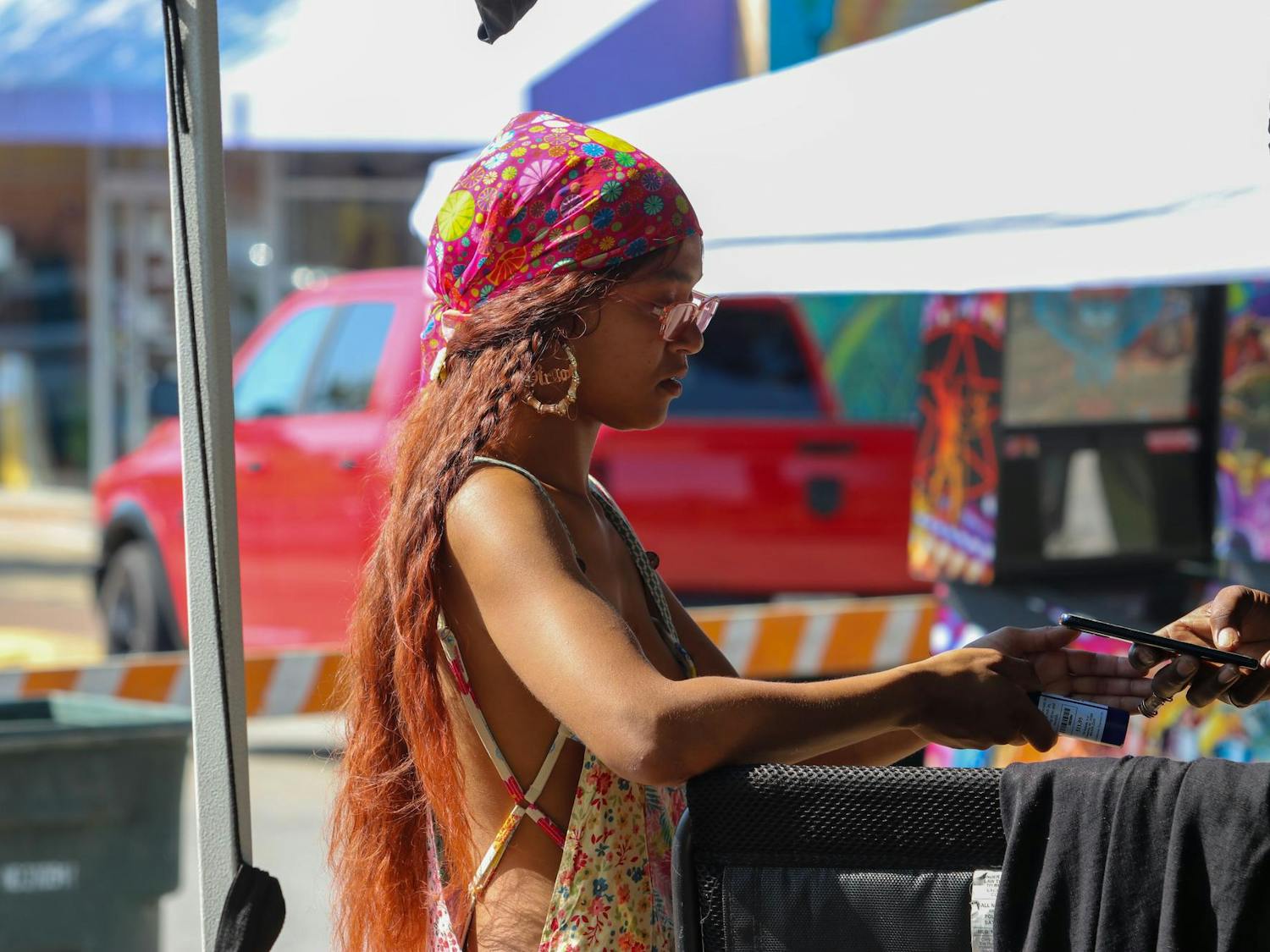 Sarah Raysor buys from a vendor at Jerry Fest on Oct. 6, 2024. Raysor was raised in the Columbia area and decided to celebrate the 10-year anniversary of the music festival in Five Points.
