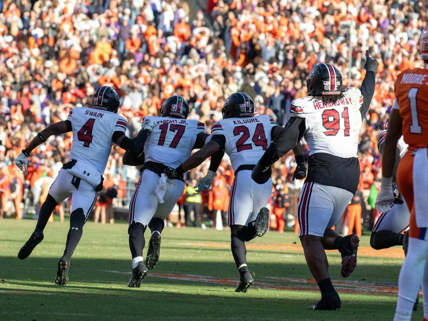Members of the South Carolina football team run down the field in excitement after sixth-year linebacker Demetrius Knight Jr intercepted the ball to secure the win against Clemson on Nov. 30, 2024. The Gamecocks defeated the Tigers by a score of 17-14 in the Palmetto Bowl.