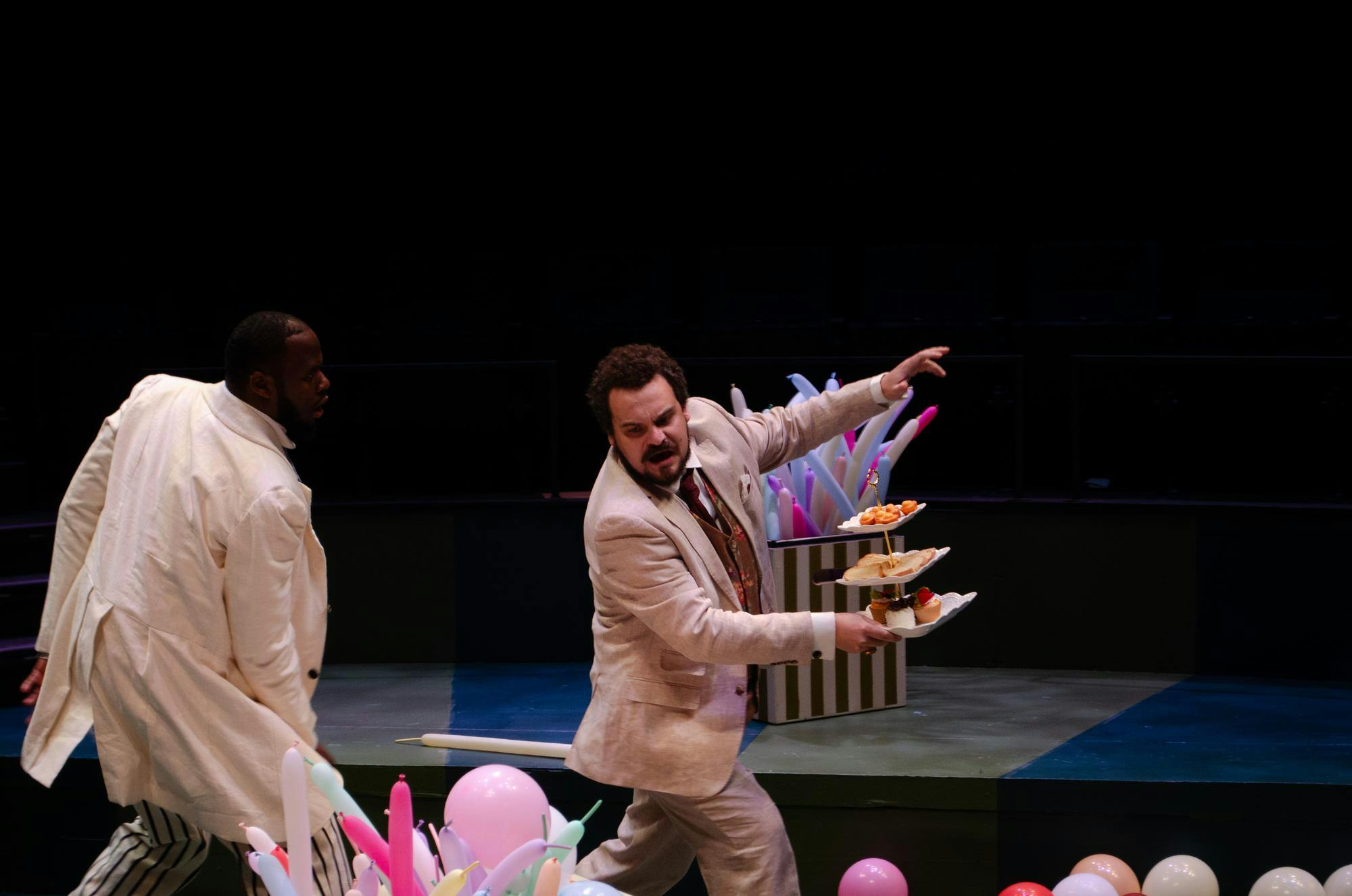 De'on Turner (left) chases Dominic Delong-Rodgers (right), who balances a pastry platter, while practicing “The Importance of Being Earnest” in Longstreet Theatre on Nov. 3, 2025. Turner and Delong-Rodgers portray Jack Worthing and Algernon Moncrieff, respectively.