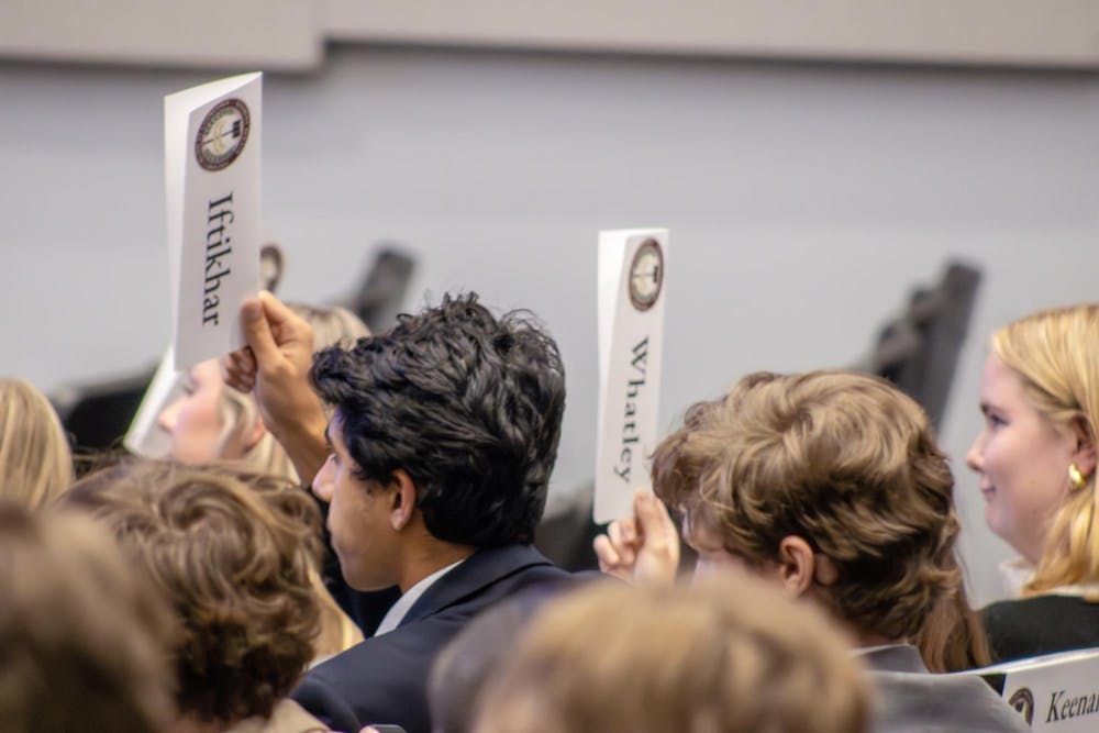 <p>Senators and secretaries from the Student Government raise their nametags to present that they have a question during a meeting on Sept. 17, 2025 in the Russell House Ballroom. The student senate meets every Wednesday at 5:30 p.m.</p>