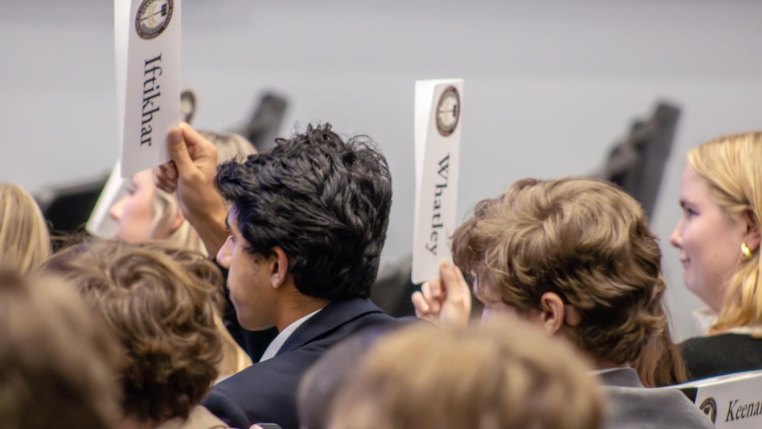 Senators and secretaries from the Student Government raise their nametags to present that they have a question during a meeting on Sept. 17, 2025 in the Russell House Ballroom. The student senate meets every Wednesday at 5:30 p.m.