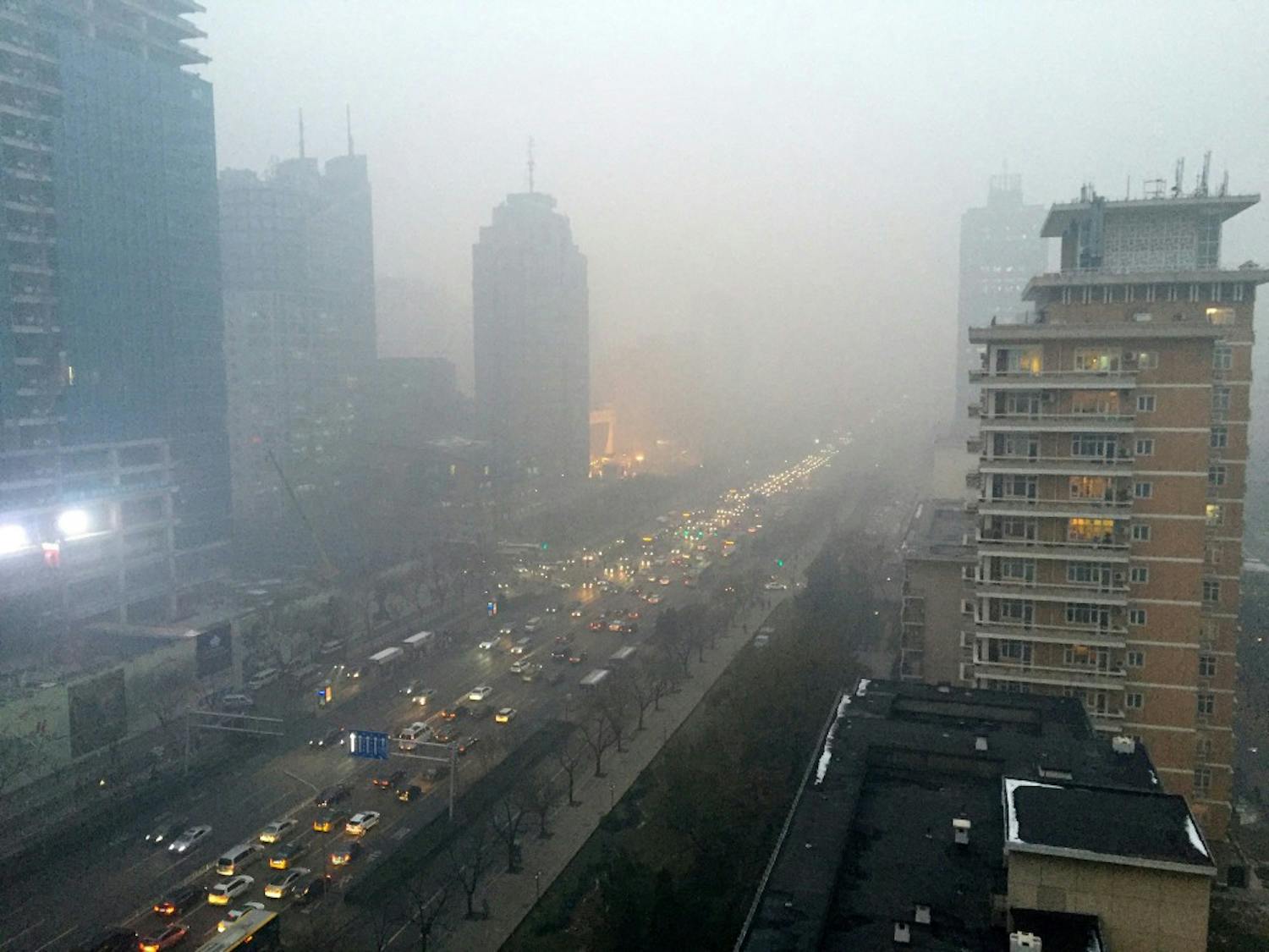 Smog hangs over Beijing's main boulevard, Chang'an Avenue, looking west toward the Forbidden City, on Monday, Nov. 30, 2015. Although the city is cracking down on dirty vehicles and some power plants, the smog of the last week has demonstrated Beijing's pollution-control efforts have yet to produce lasting results. It comes as Chinese President Xi Jinping is in Paris pledging that China will reduce emissions linked to global climate change.  (Stuart Leavenworth/McClatchy/TNS) 