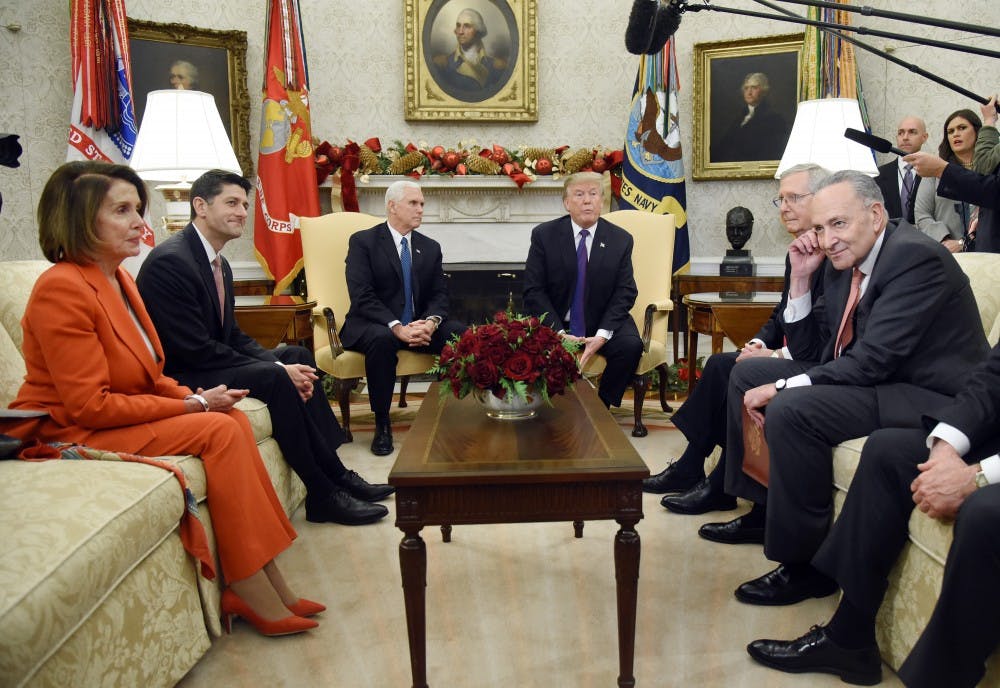 U.S. President Donald Trump and Vice President Mike Pence look on during a meeting with Congressional leadership including House Minority Leader Rep. Nancy Pelosi (D-Calif.), House Speaker Paul Ryan (R-Wis.), Senate Majority Leader Mitch McConnell, and Sen. Charles Schumer (D-NY) in the Oval Office of the White House Thursday, Dec. 7, 2017 in Washington, D.C.  (Olivier Douliery/Abaca Press/TNS) 