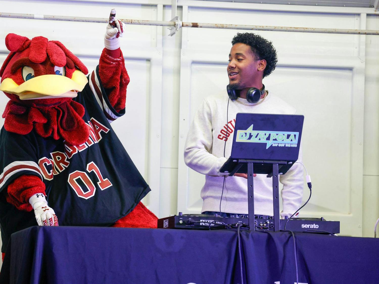 Cocky stands on stage next to South Carolina alumni DJ Zay Pola at Tiger Burn on Nov. 20, 2024. DJ Zay Pola provided music for the event.