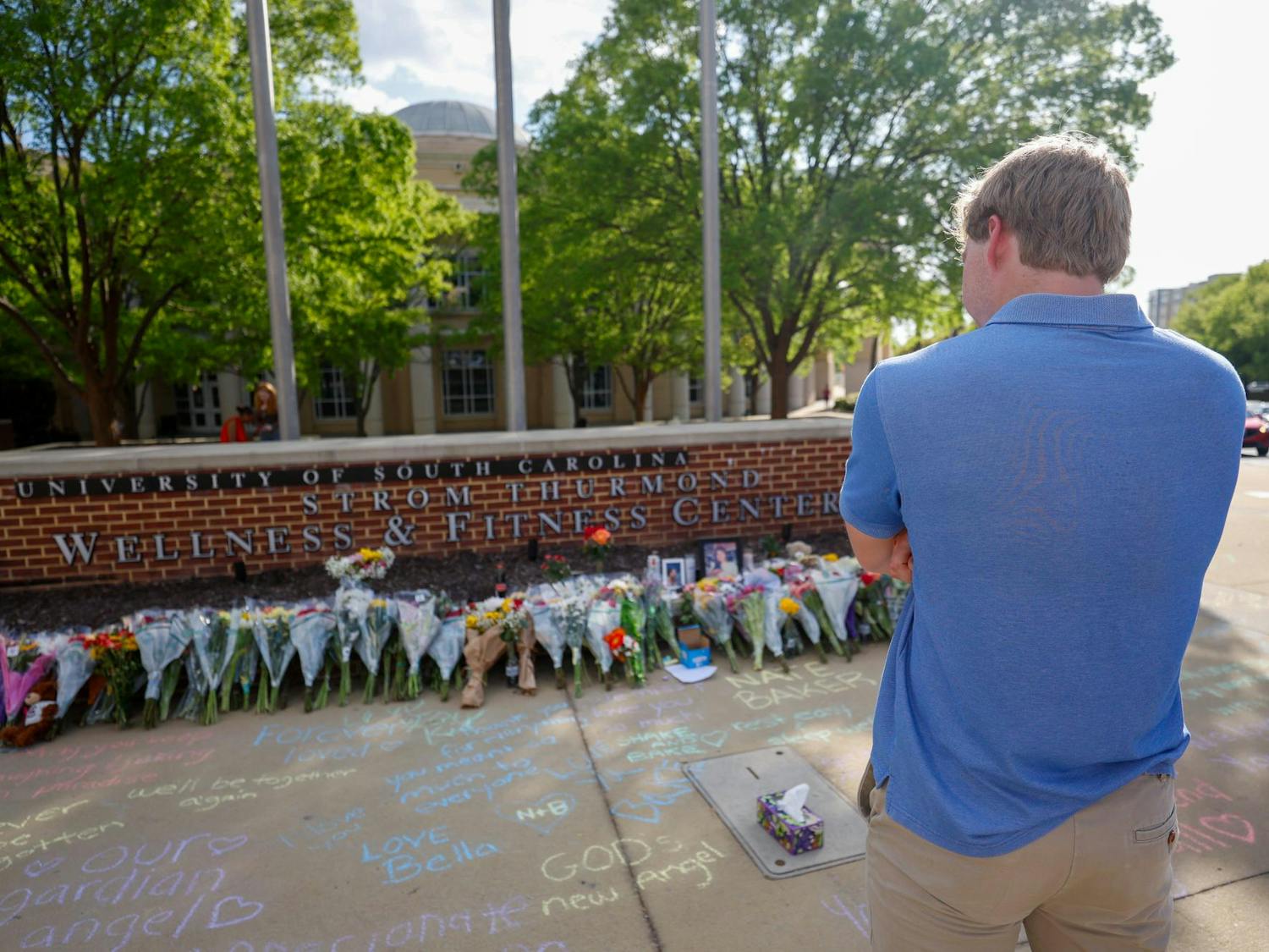 A student stands outside the memorial for Nathaniel "Nate" Baker outside Strom Thurmond Wellness and Fitness Center on April 3, 2025. Dozens of students left flowers in honor of Baker, who was struck and killed the previous day by an oncoming truck the previous day.