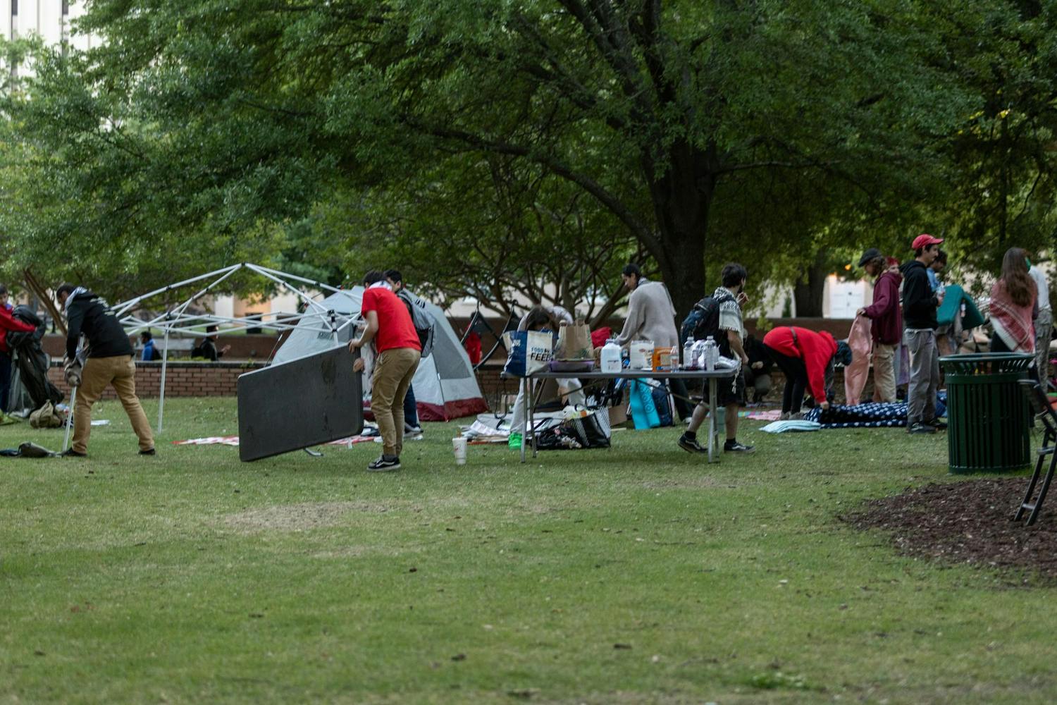 Protestors break down their tents and clean up Davis Field after spending the day in protest of the university’s Israeli-connected investors. Protestors gathered in response to actions on other college campus' across the country. "I feel like it scared the school a little bit, which is always a good thing," third-year sociology major Andrés Gonzalez said.