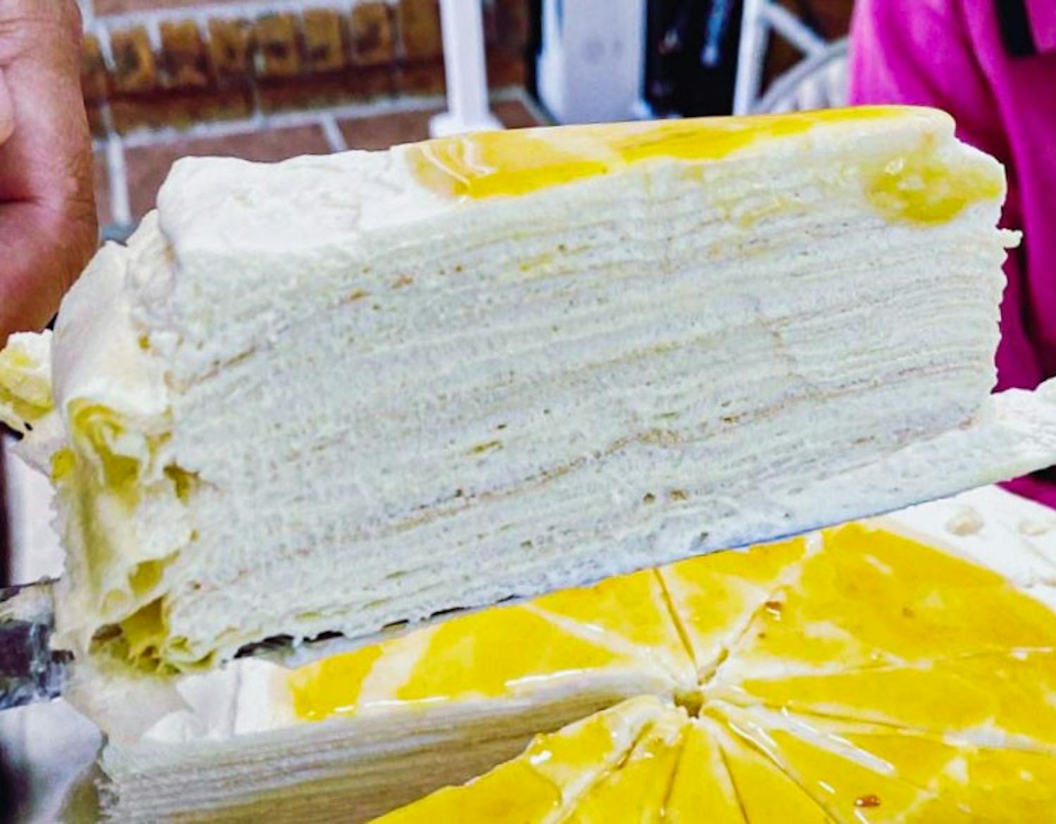 A slice of Yuzu crepe cake, one of CreamxSugar's, most popular Asian-inspired deserts on Saturday, June 19, 2021. The French-Asian-style online bakery offers a variety of cakes and pastries available for order through their Instagram page.