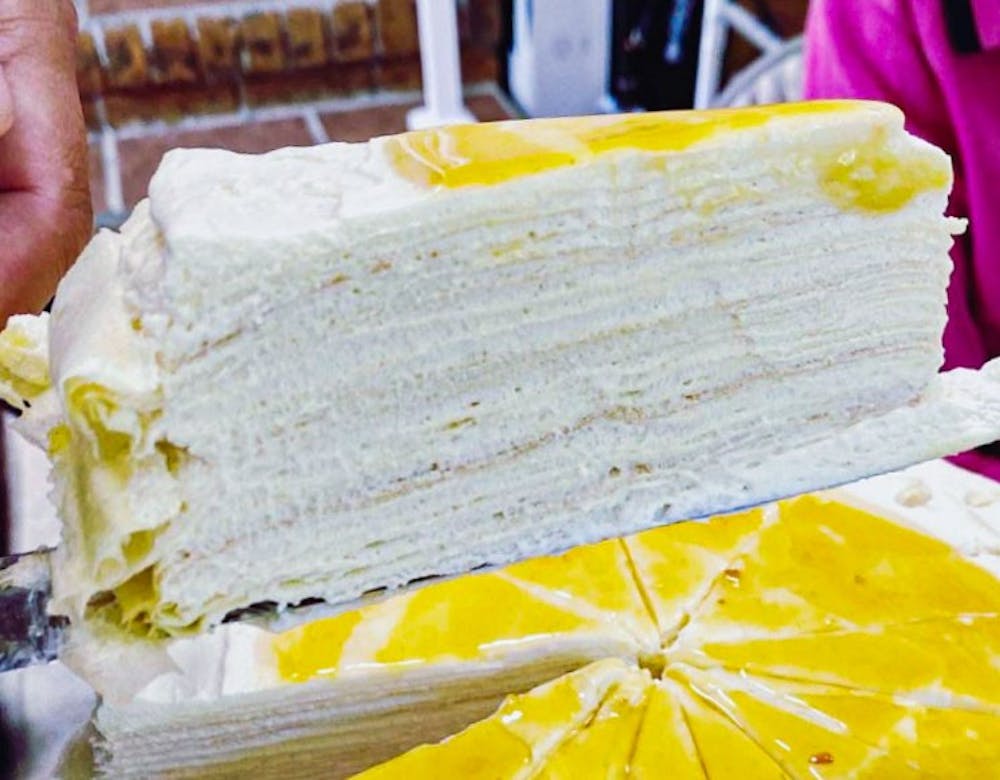 <p>A slice of Yuzu crepe cake, one of CreamxSugar's, most popular Asian-inspired deserts on Saturday, June 19, 2021. The French-Asian-style online bakery offers a variety of cakes and pastries available for order through their Instagram page.</p>