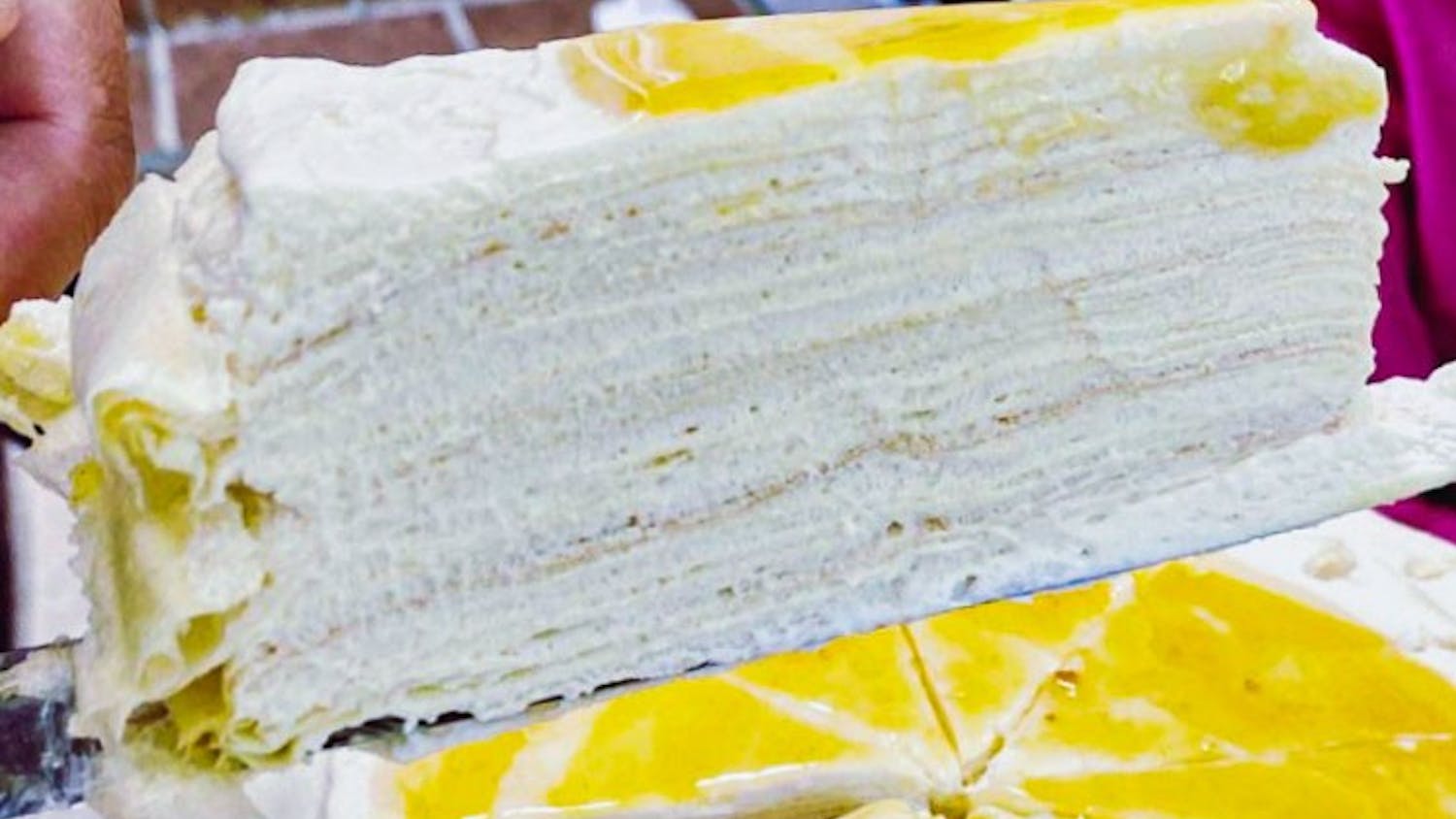 A slice of Yuzu crepe cake, one of CreamxSugar's, most popular Asian-inspired deserts on Saturday, June 19, 2021. The French-Asian-style online bakery offers a variety of cakes and pastries available for order through their Instagram page.