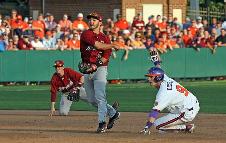 South Carolina Gamecocks&apos; Max Schrock completes a double play against Clemson at Doug Kingsmore Stadium in Columbia, S.C., on Sunday, March 2, 2014. (Dwayne McLemore/The State/MCT)